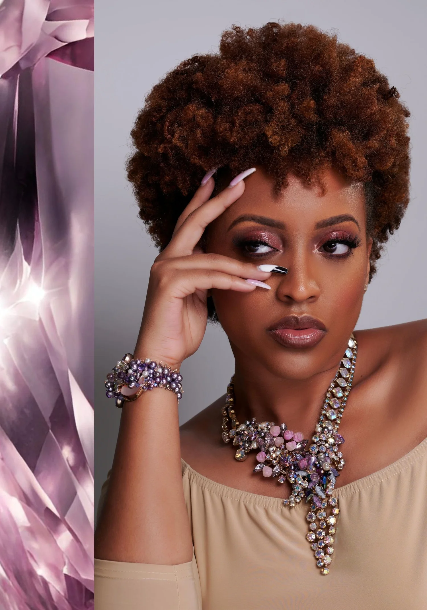 A model with short curly auburn hair, one hand raised to her face, wearing a vintage crystal statement necklace with pink and iridescent stones and a purple pearl bracelet, beside a close-up of faceted lilac crystal