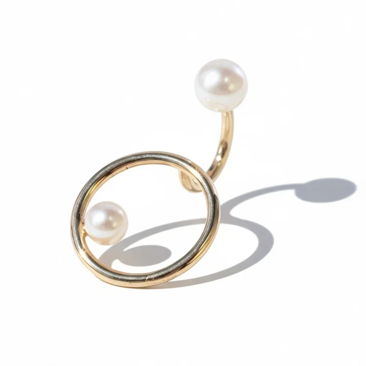 A gold open-circle ring with two pearls