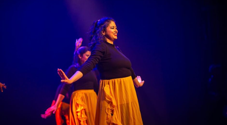  Three women dancing onstage in costumes 