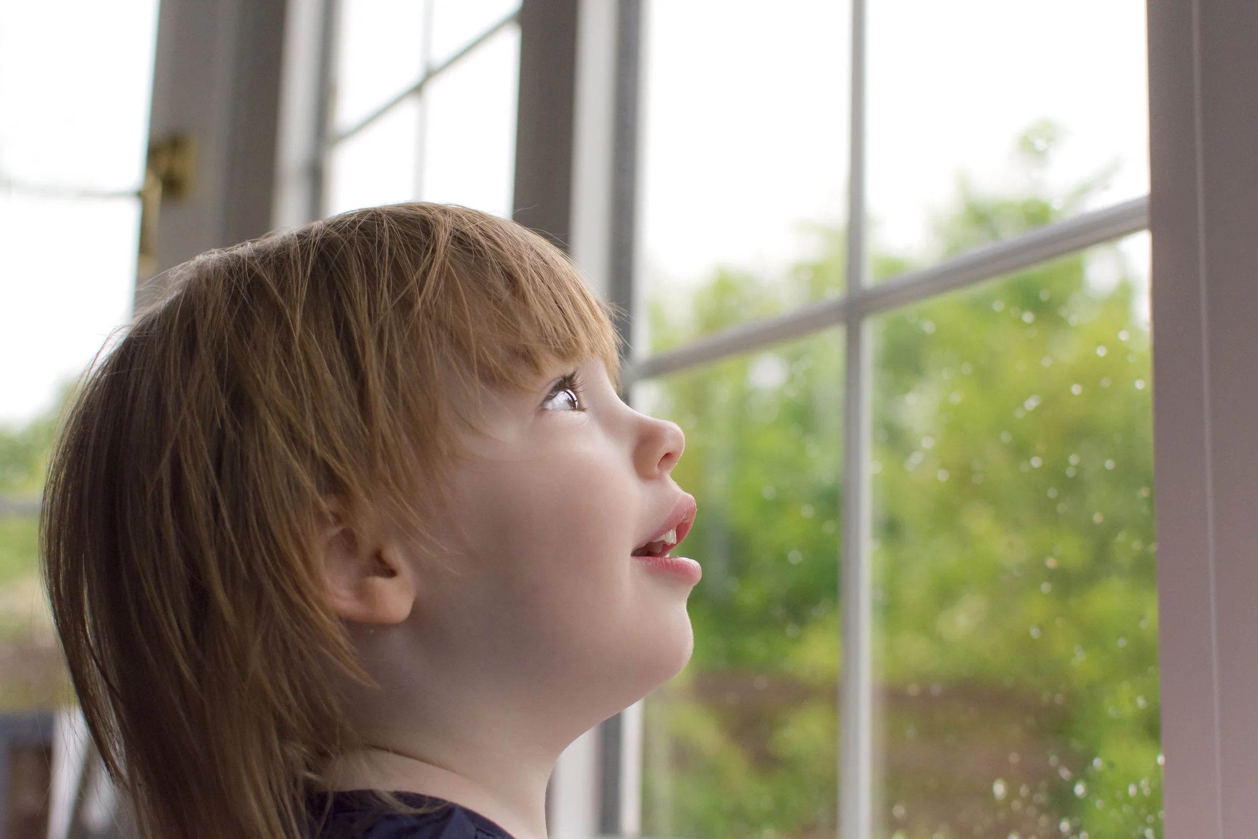 girl looking out window home photoshoot