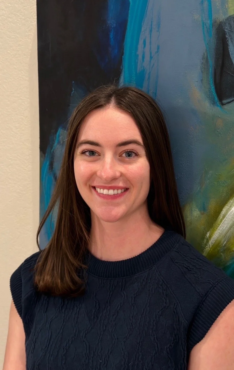 person smiling with long brown hair