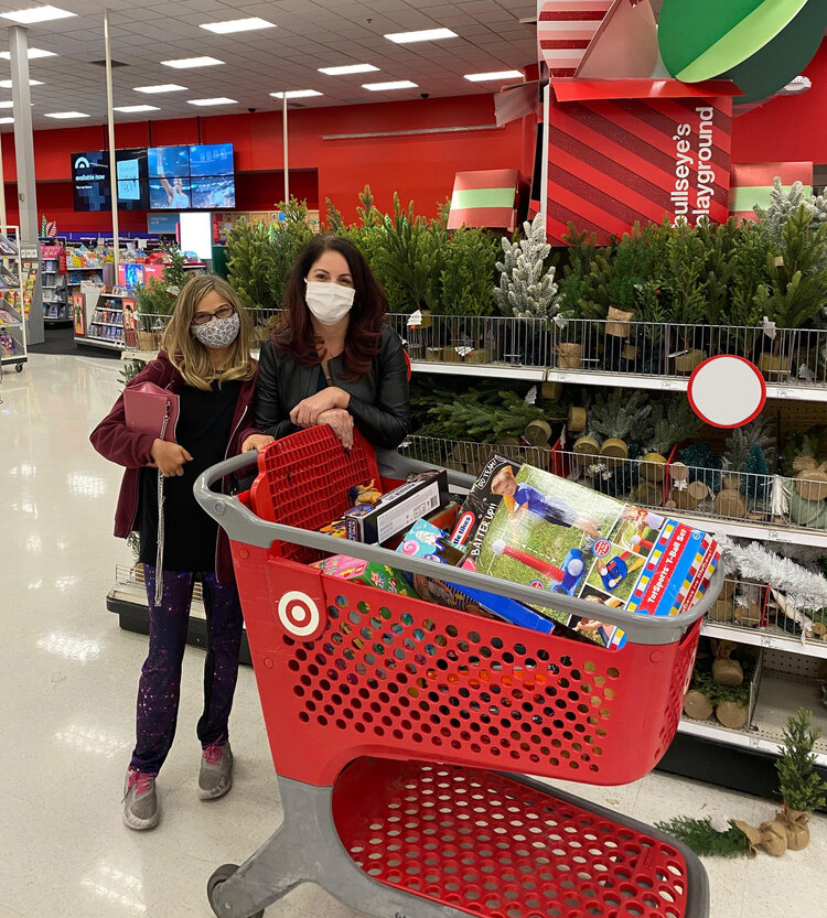 Liz, Robert and the Werner Family are seen here busy filling up a cart with toys that will go into in the Toys For Tots box.  Help us fill it up to overflowing! 