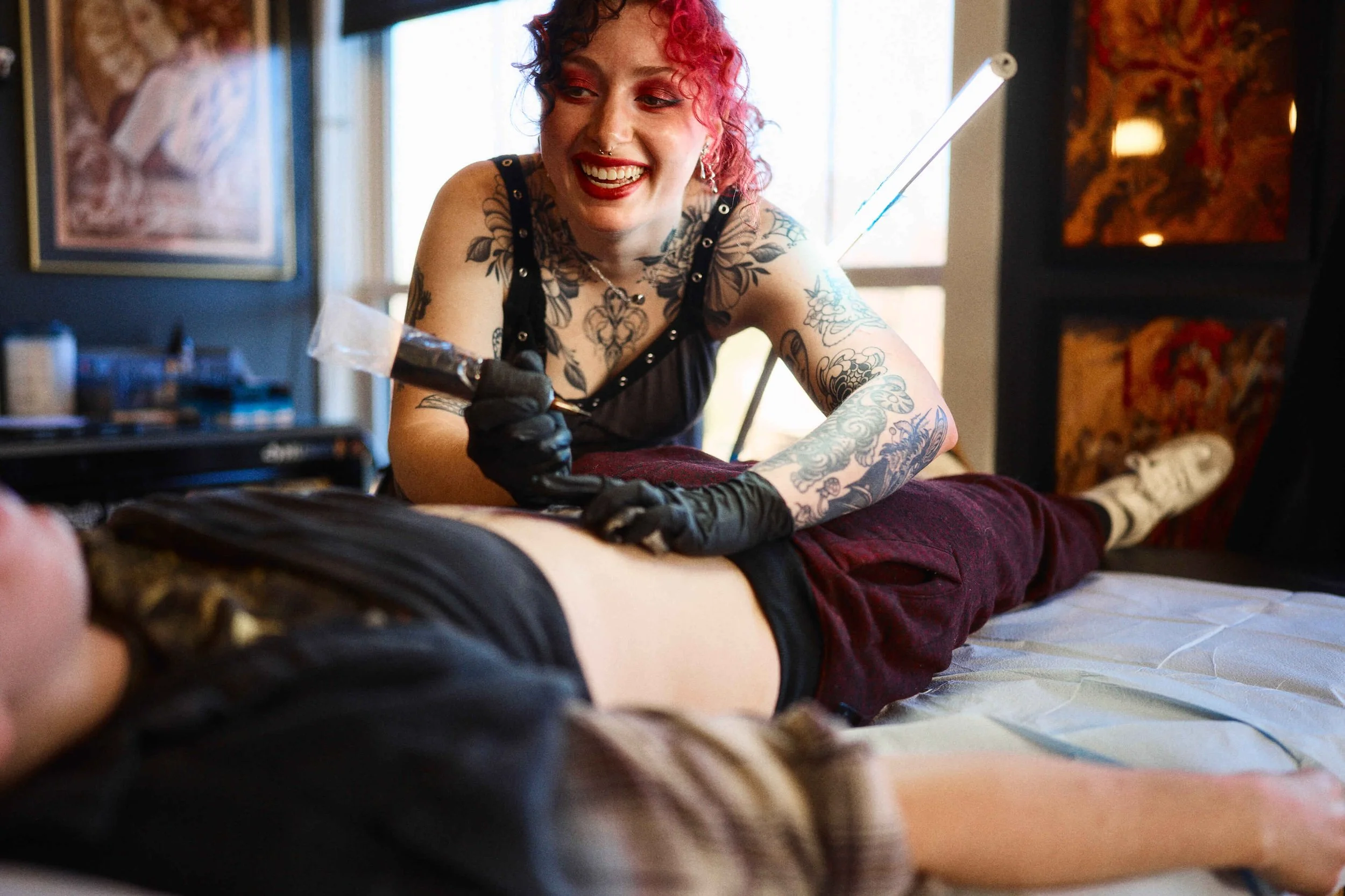 Tattoo artists at work at Safe House Tattoo Studio in Nashville