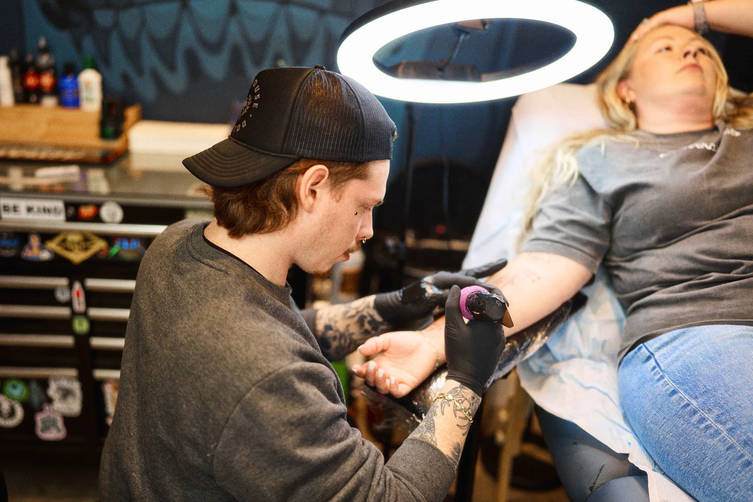 Chris Mullins tattooing a black and grey tattoo on a client at Safe House Tattoo Studio in Nashville, Tennessee.