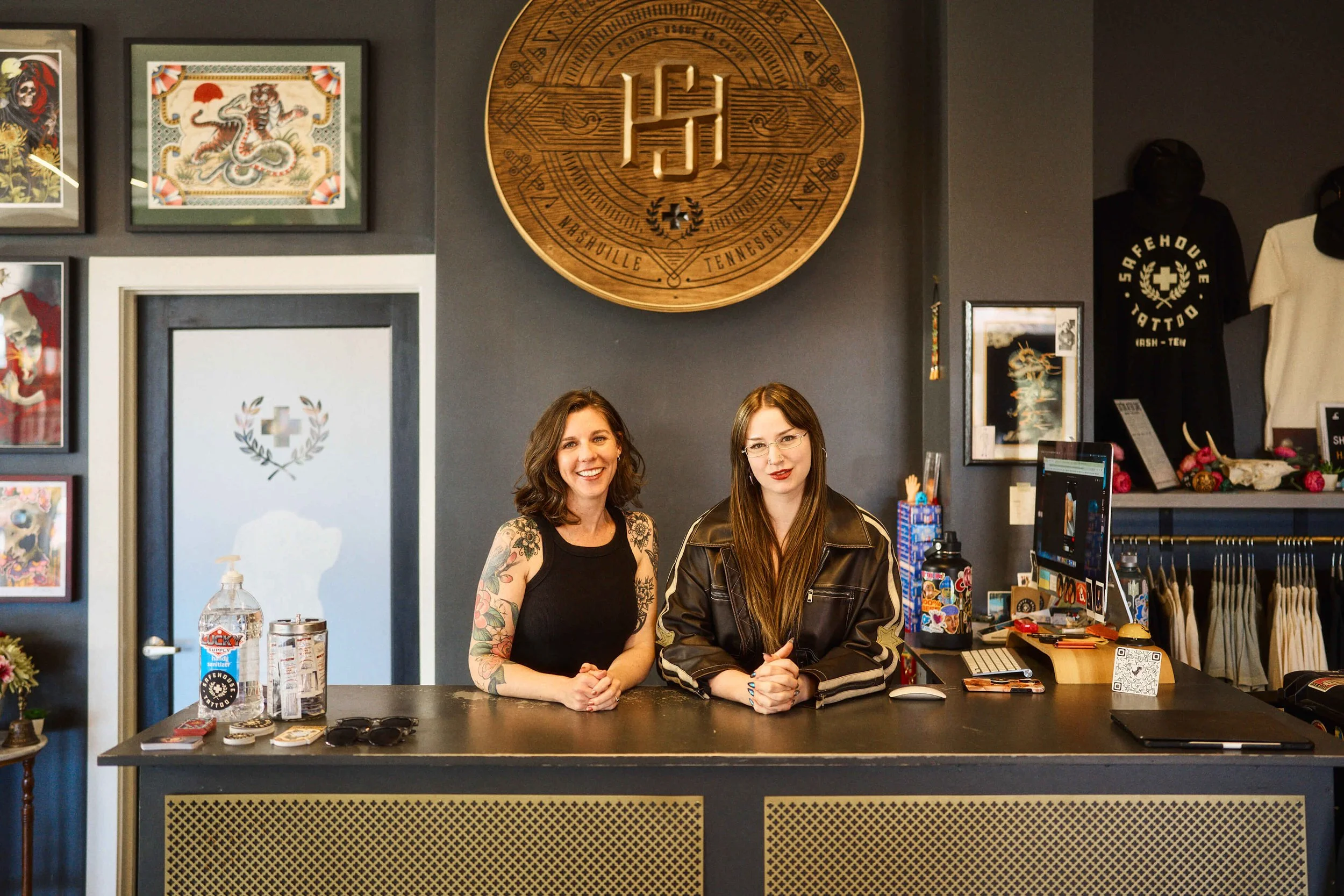 Safe House Tattoo Studio staff at the front desk in Nashville helping clients choose the right tattoo artist