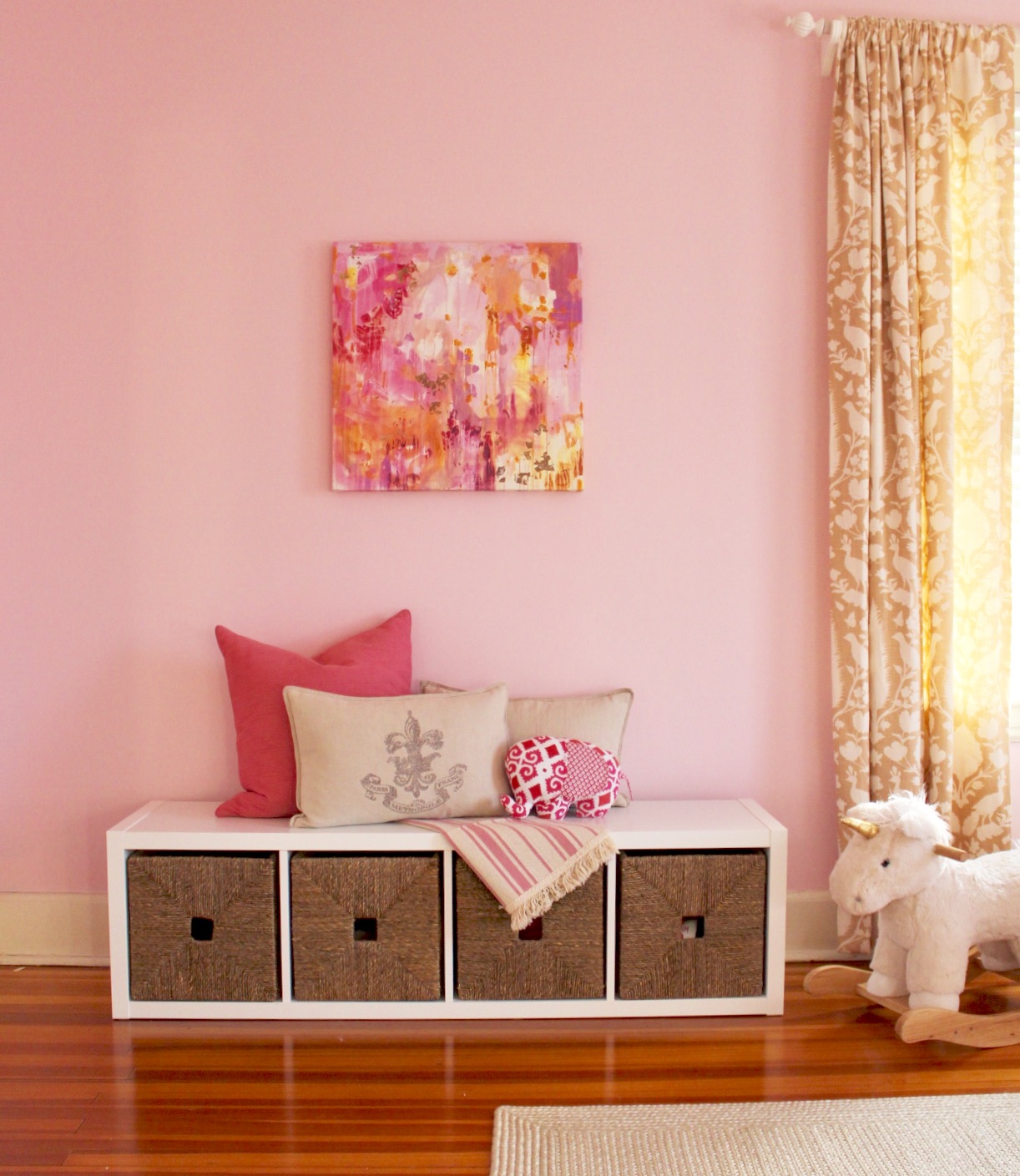 This shelf has been the most practical addition! I love the extra storage it provides us with, and it is a perfect reading nook. It sits below the art that inspired the room's entire color palette.