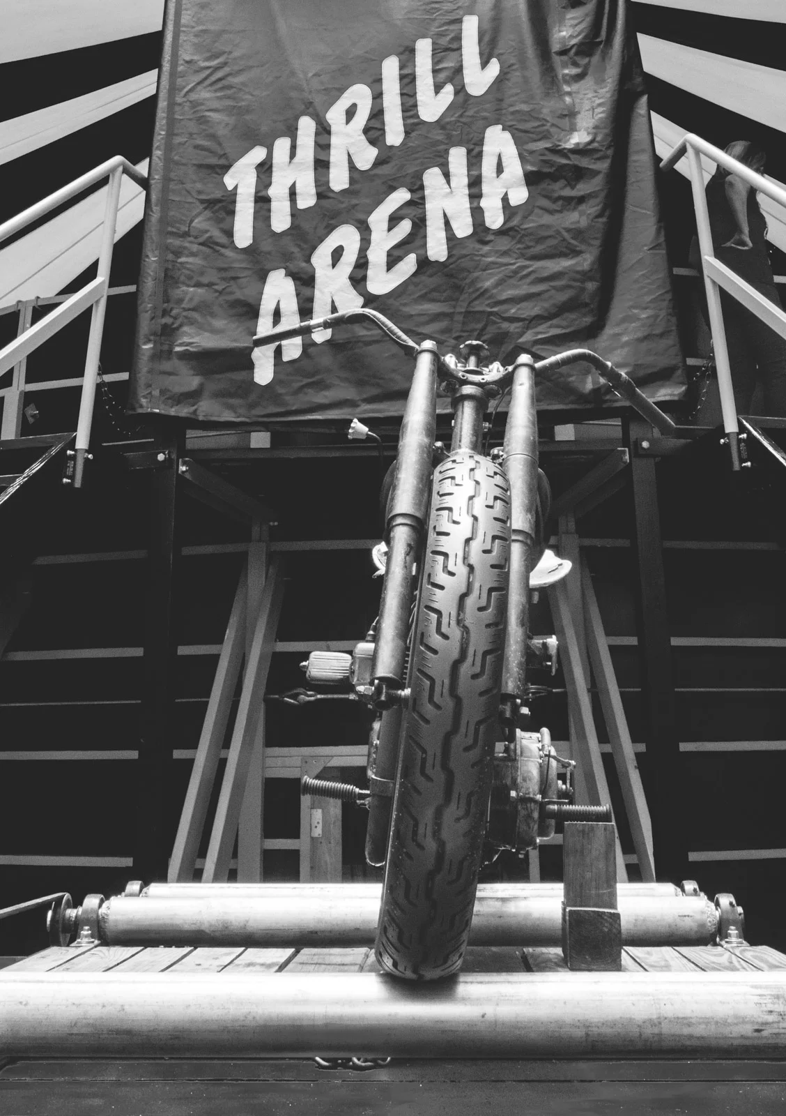 A vintage Indian motorcycle sits on the bally rollers in front of the Thrill Arena. "Bally" is an old sideshow term meaning a free show used to draw customers into the main attraction.