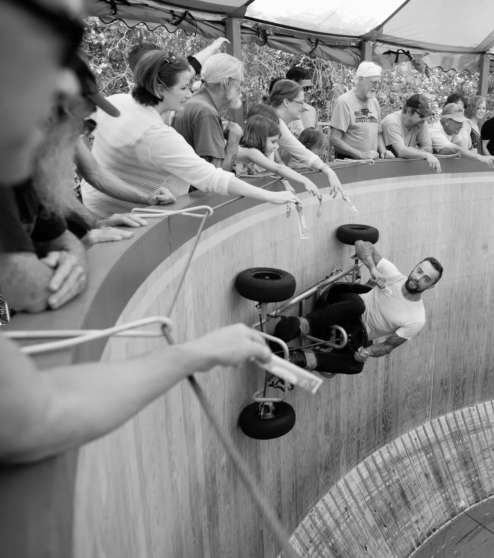 Jake "Cyclone" Wheeler takes the Wild Wheels racing go kart to the top of the wall and grabs bills directly from spectator's hands.