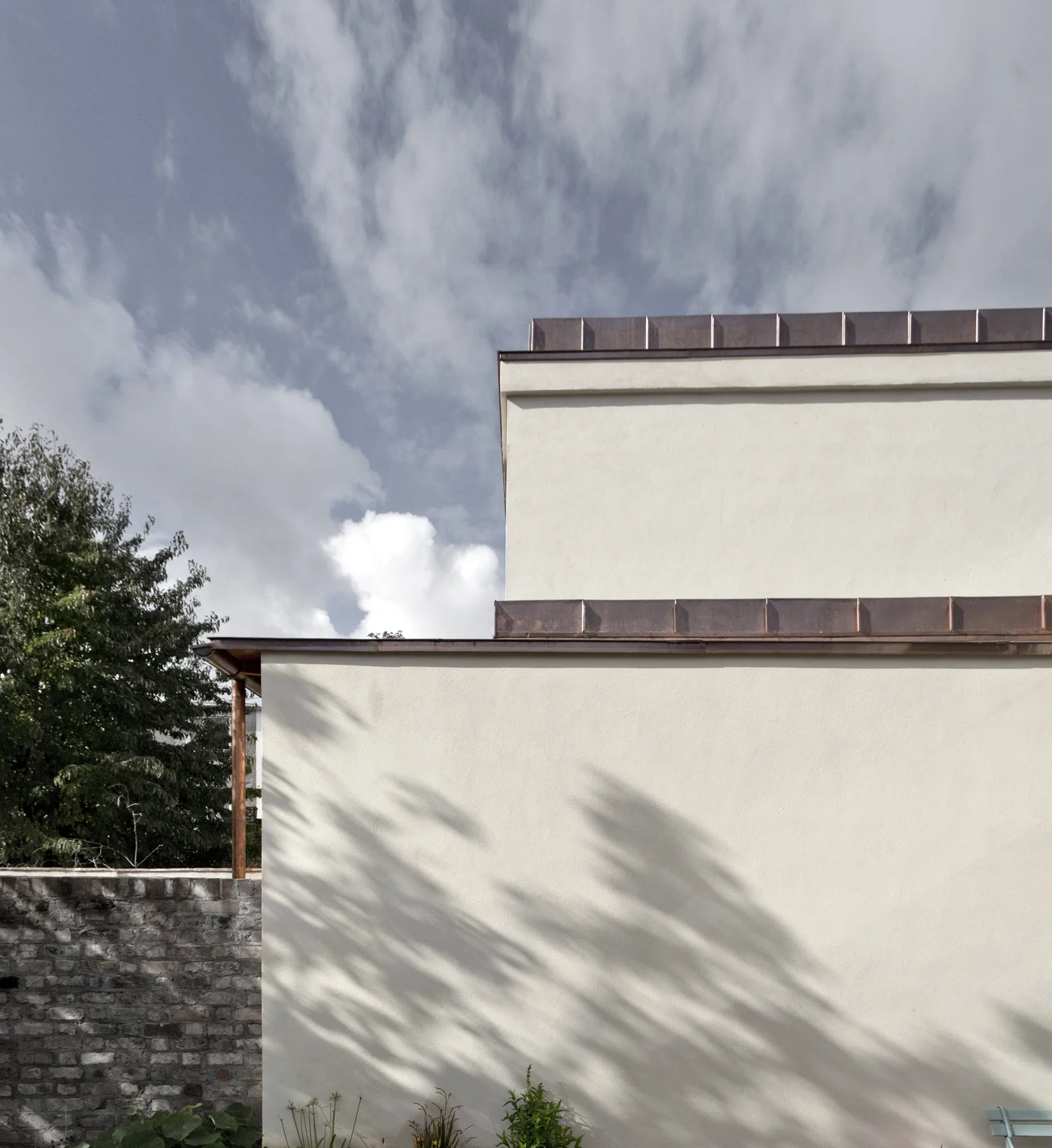 The new extension features natural materials including copper, lime render and terracotta drawn from the original house