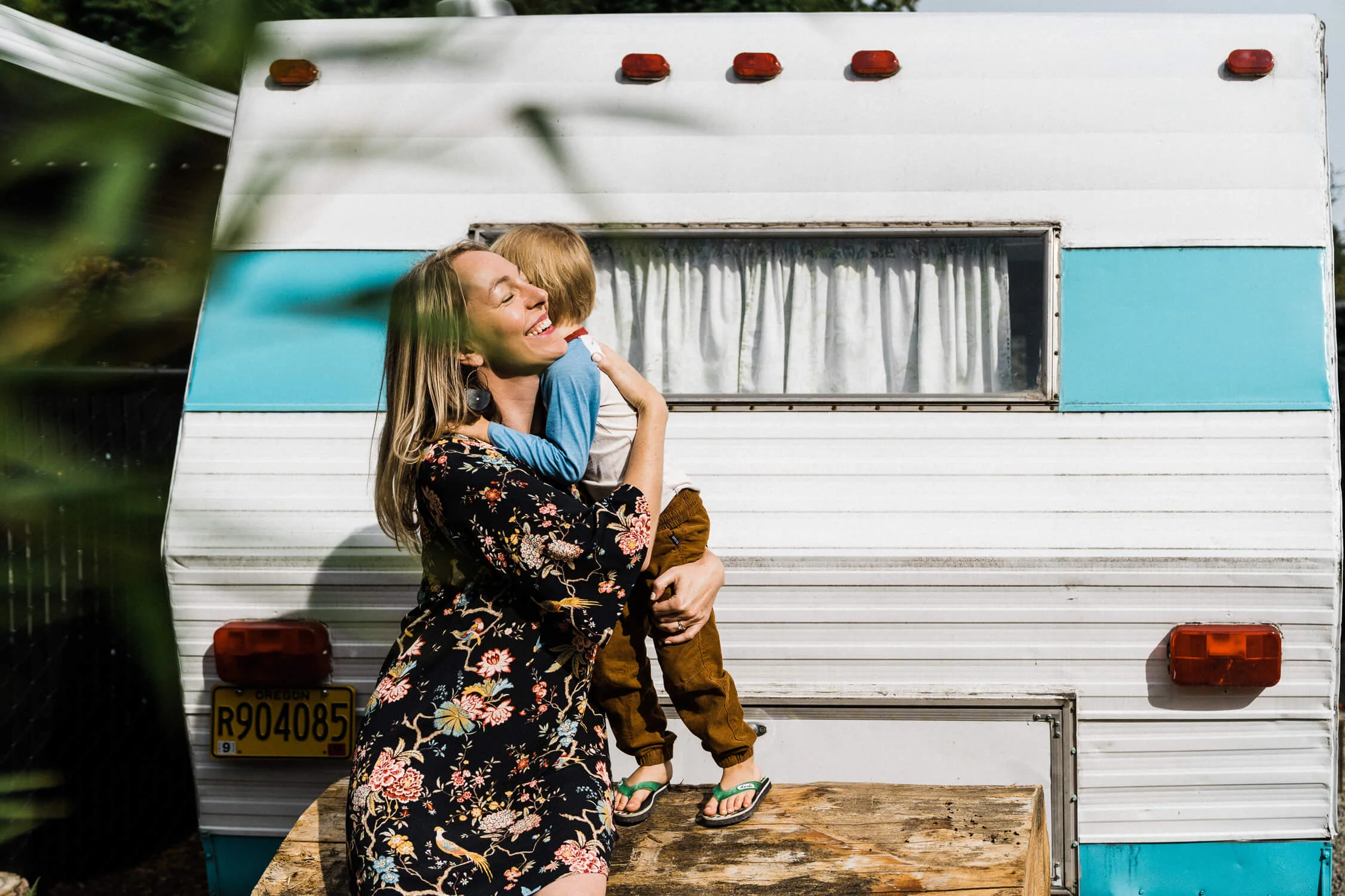 camper trailer hip turquoise vintage plants mom child hug