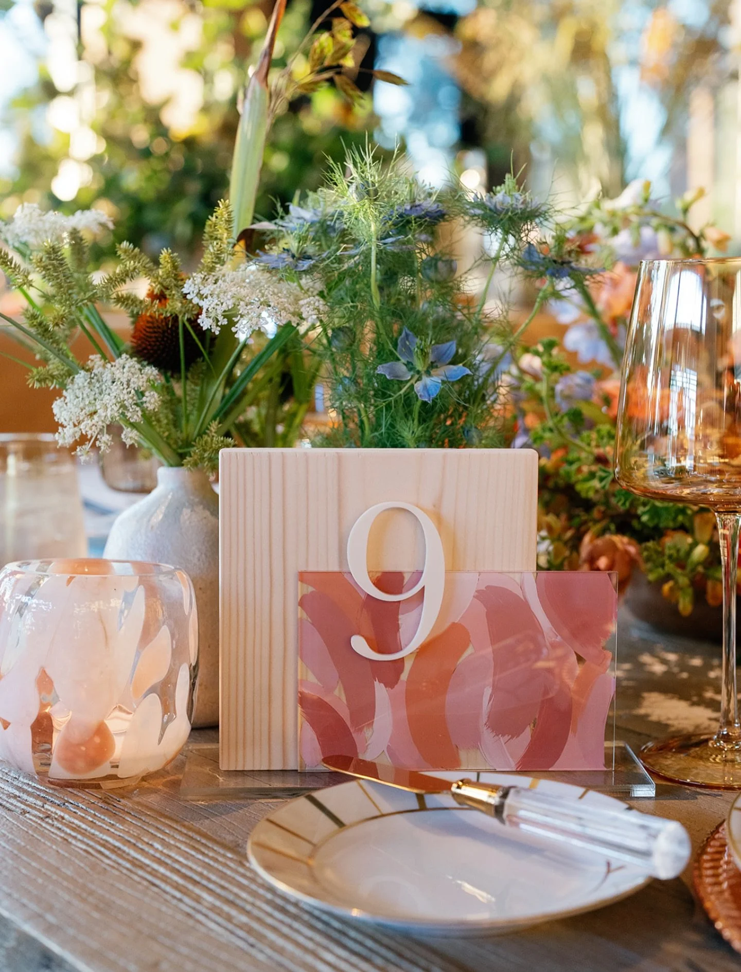 Hand painted acrylic and wood table numbers inspired by the beautiful candle votives from @theonicollection adding a bright pop of color to the tables.

Planning and Design: @asavvyevent 
Photography: @garrettrichardson 
Floral Design: @vignetteflora