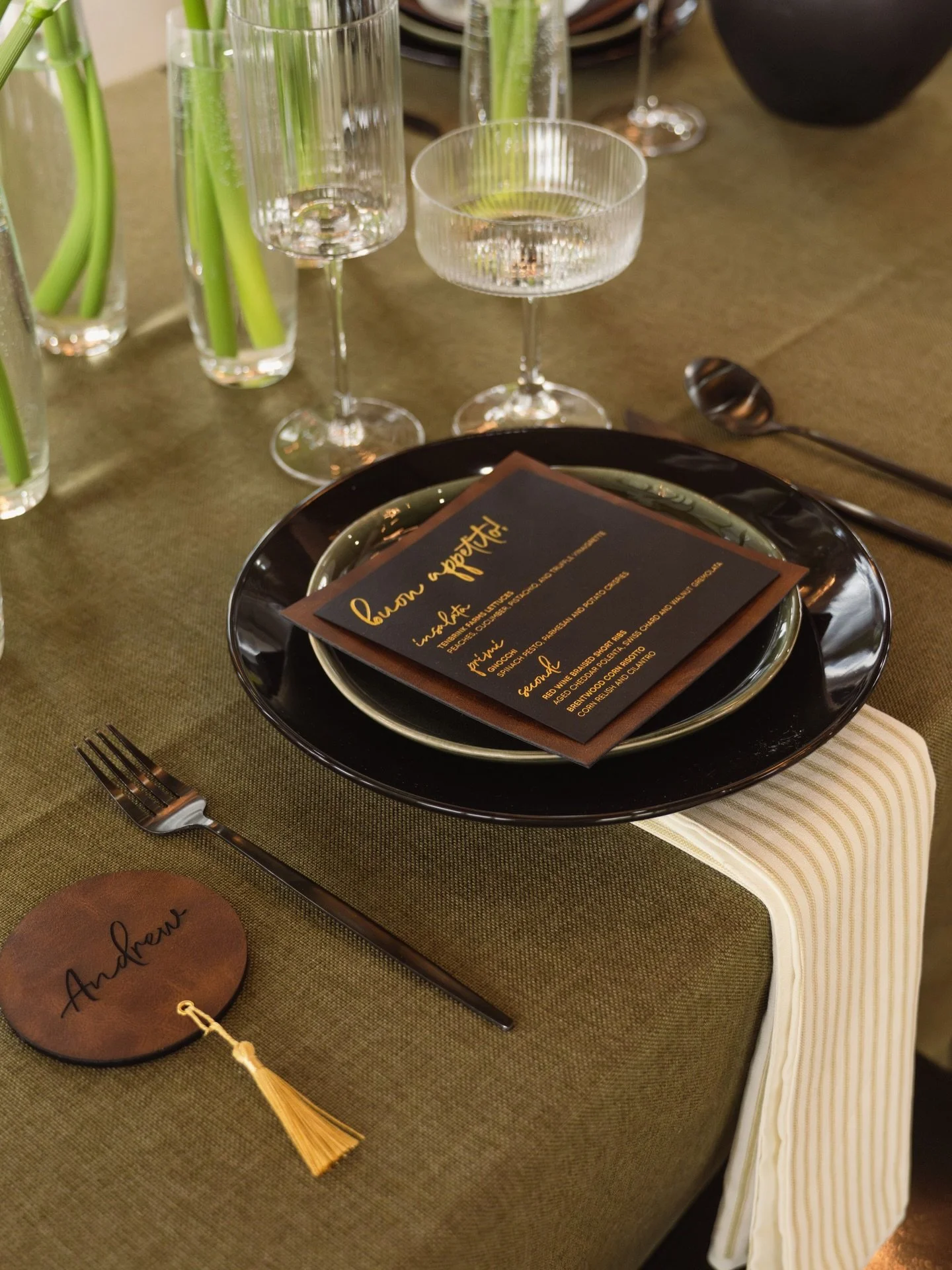 Leather, black cardstock and gold foil stamped menu, leather and acrylic engraved place card with a tassel, yes please!

Photographer: @vvinncentttord @alesonphotography 
Venue: @_themargaux 
Rentals: @cteventrental @letspartyprettier @thelinenshoppe
