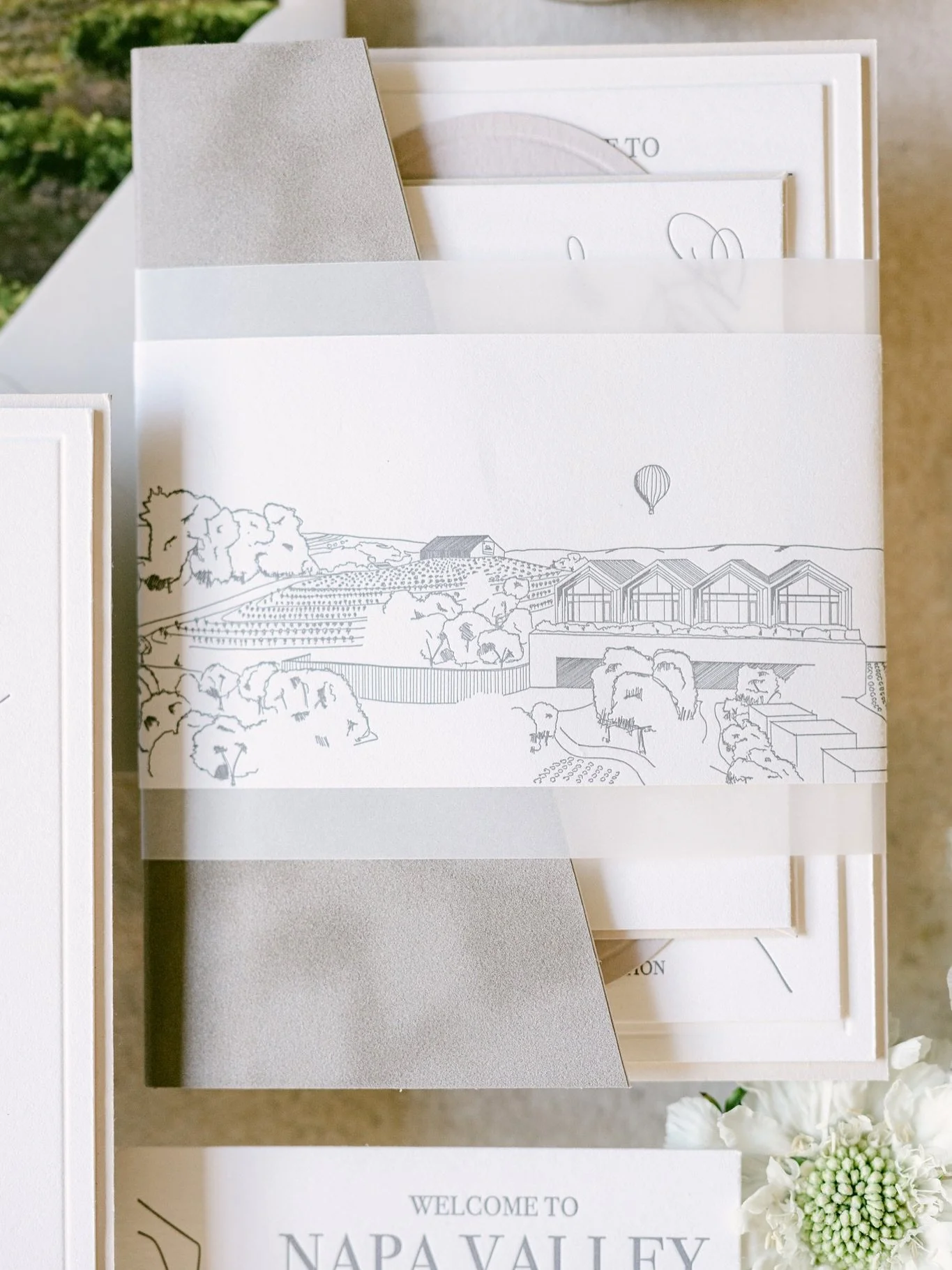 A close-up look at the custom made velvet folios for Kennidy and Evan&rsquo;s beautiful wedding &mdash; the shape was inspired by architecture at Stanly Ranch. The groom is an architect himself and sketched the venue to be used on various printed pie