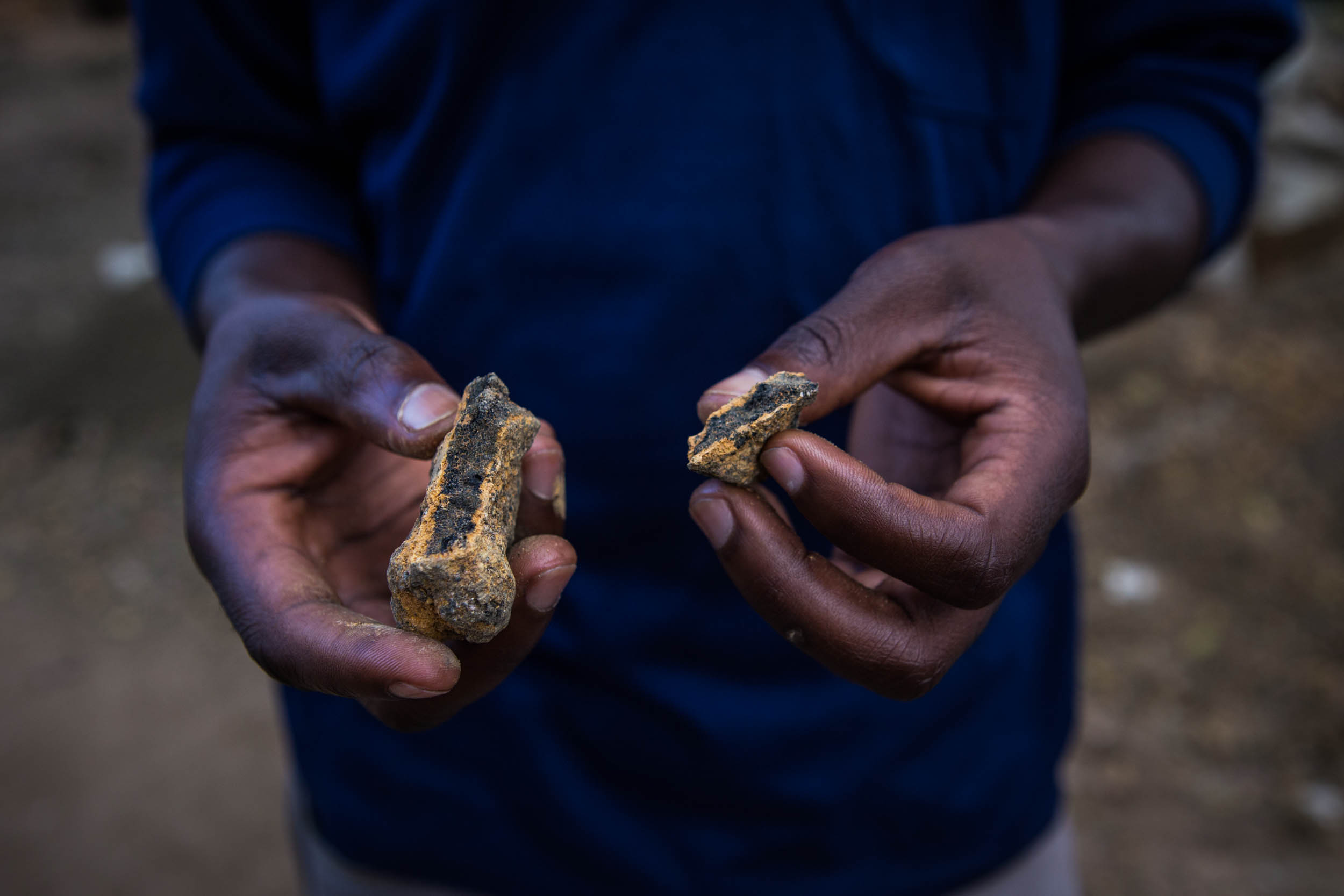  A digger is holding a Cobalt stone at Ndari artisinal mine, Haut Katanga. Men and children working in the artisanal mines are exposed to the toxics, including also high levels of uranium. 