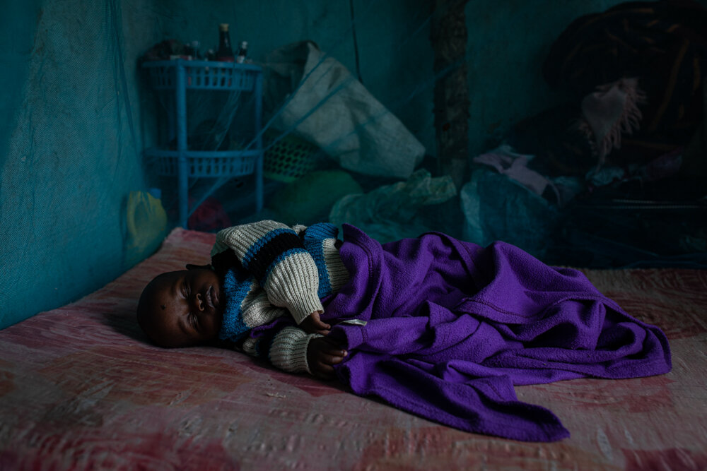  Ten-month-old Prince Jackson sleeps under a mosquito net at his home in  Kakamega County, Kenya. He’s received two of the four doses of malaria  vaccine so far. 