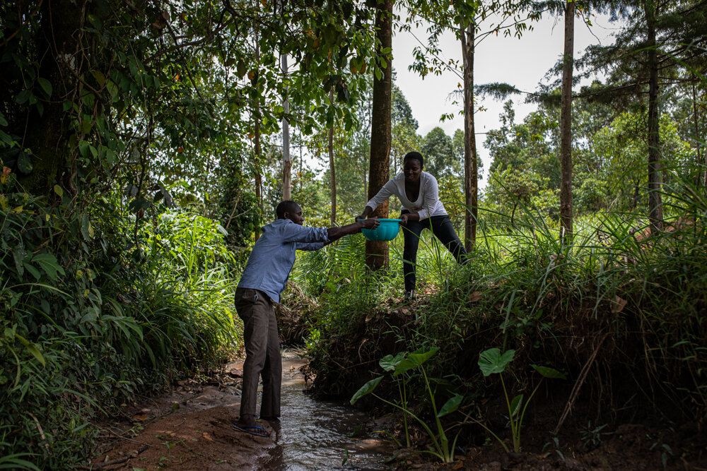  Vincent Olang’ and Violet Wachiya fetch water from a small river near their house. They’ve tried to drain the stagnant water to discourage mosquitos from breeding there, but with little success. 