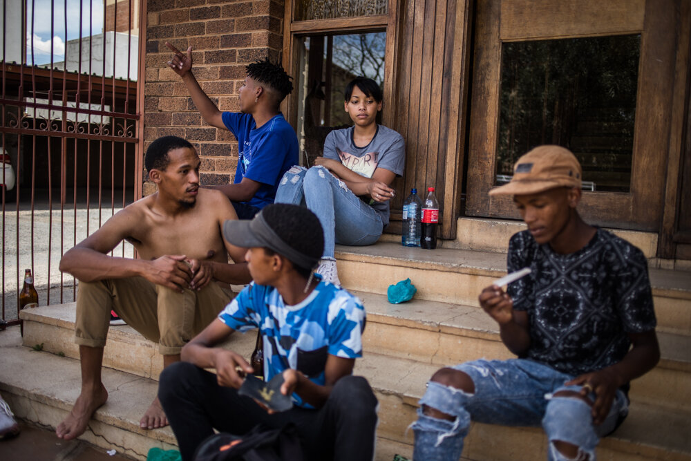  Sheri meets her brothers friends on a Saturday afternoon in front of her apartment in Belgravia, Kimberley. “I don’t like that they drink so much and party. But here in Kimberley there is nothing more to do”. 