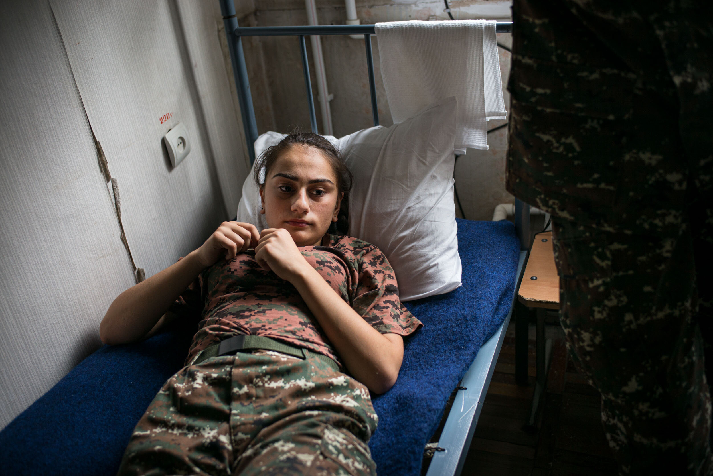  One of the teenage girls rests in their dormitory at Stepanakert Military High School in Nagorny Karabakh. 