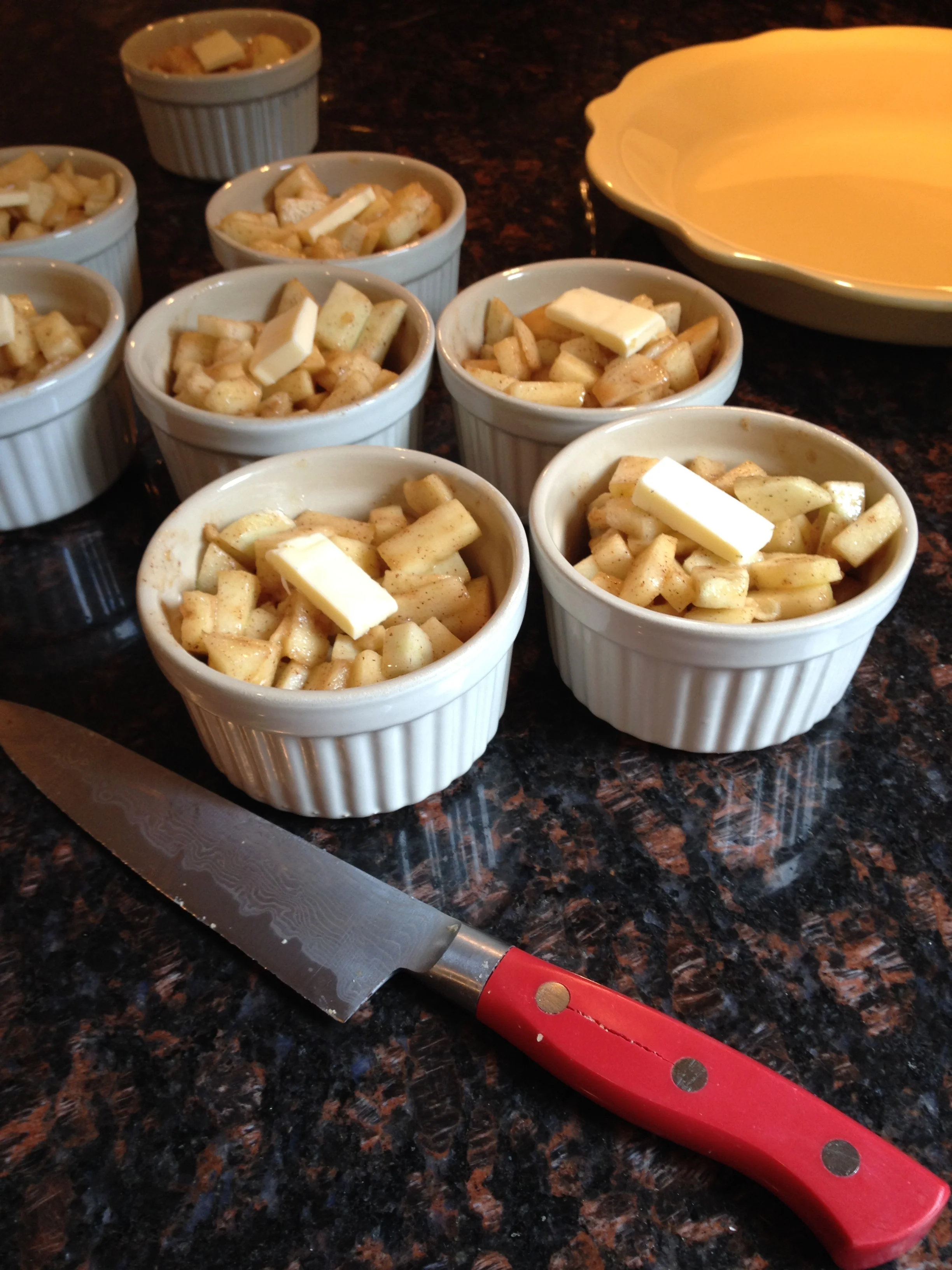Butter dotting the top of the mini apple pies. Note the crack on my knife.... this is what happened when I not thinking and put it in the dishwasher vs hand washing.