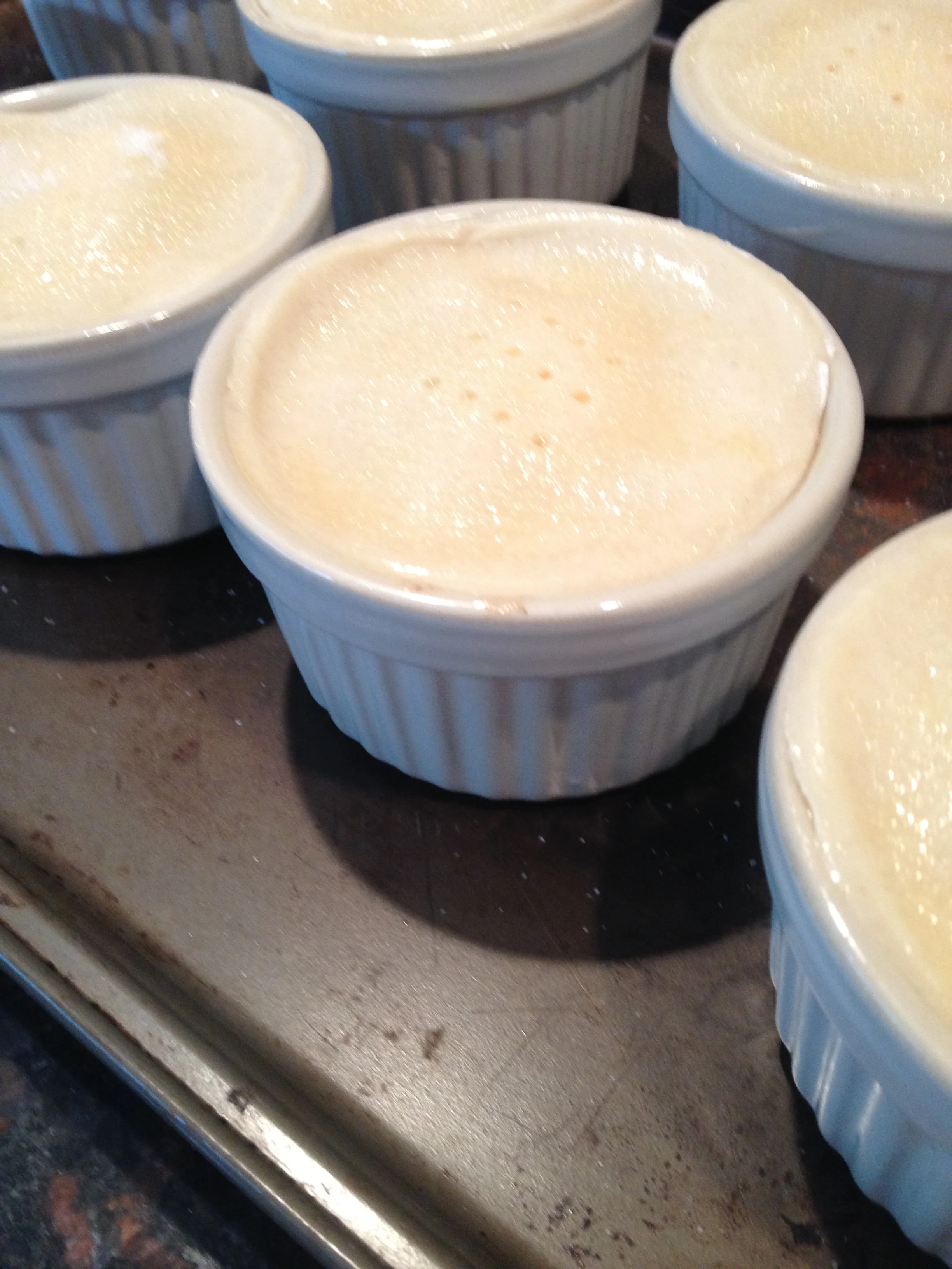 Each mini apple pie was then covered with a circle of pie crust (I used a drinking glass that had the same circumference to cut the circles) that was then brushed with butter. I then sprinkled cinnamon sugar on top. Use a fork to add a row of mini steam holes.