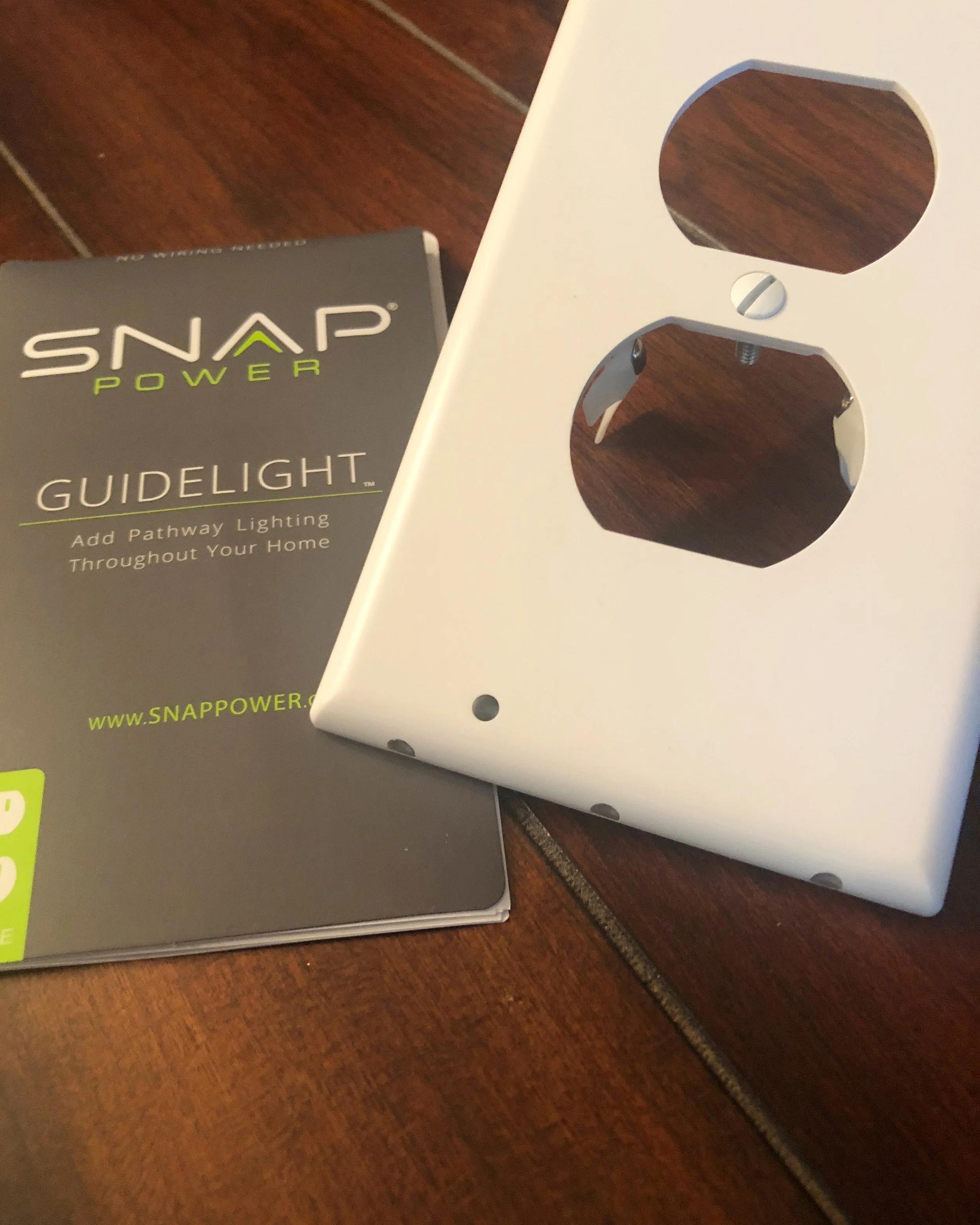 The Snap Power Guidelight has lights along the bottom with a light sensor of the face of the plate.