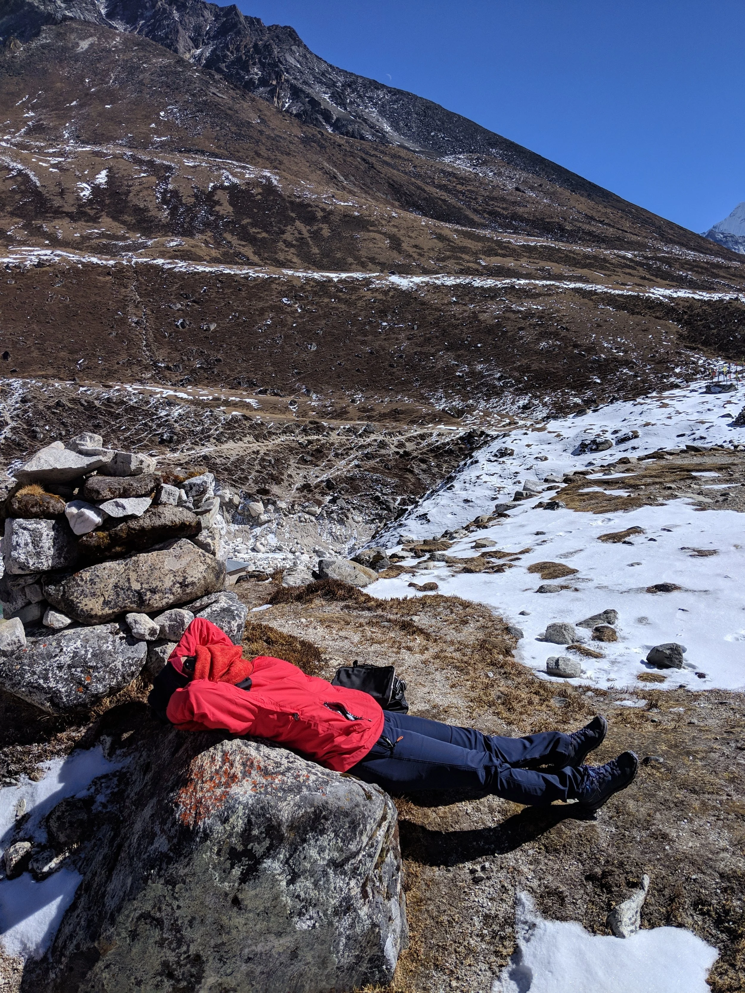 Basking in the sun atop one of the peaks- the only way to thaw!