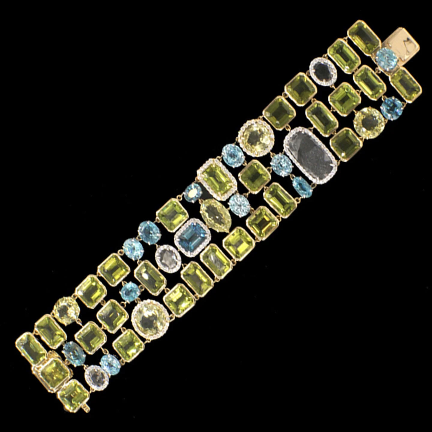  Zamba Bracelet    $84,800.00      A fabulously flexible bracelet, composed of different shades and cuts of natural gemstones and diamonds, set in eighteen-karat white and yellow gold. The bracelet features mainly peridots and sillimanites in a strik