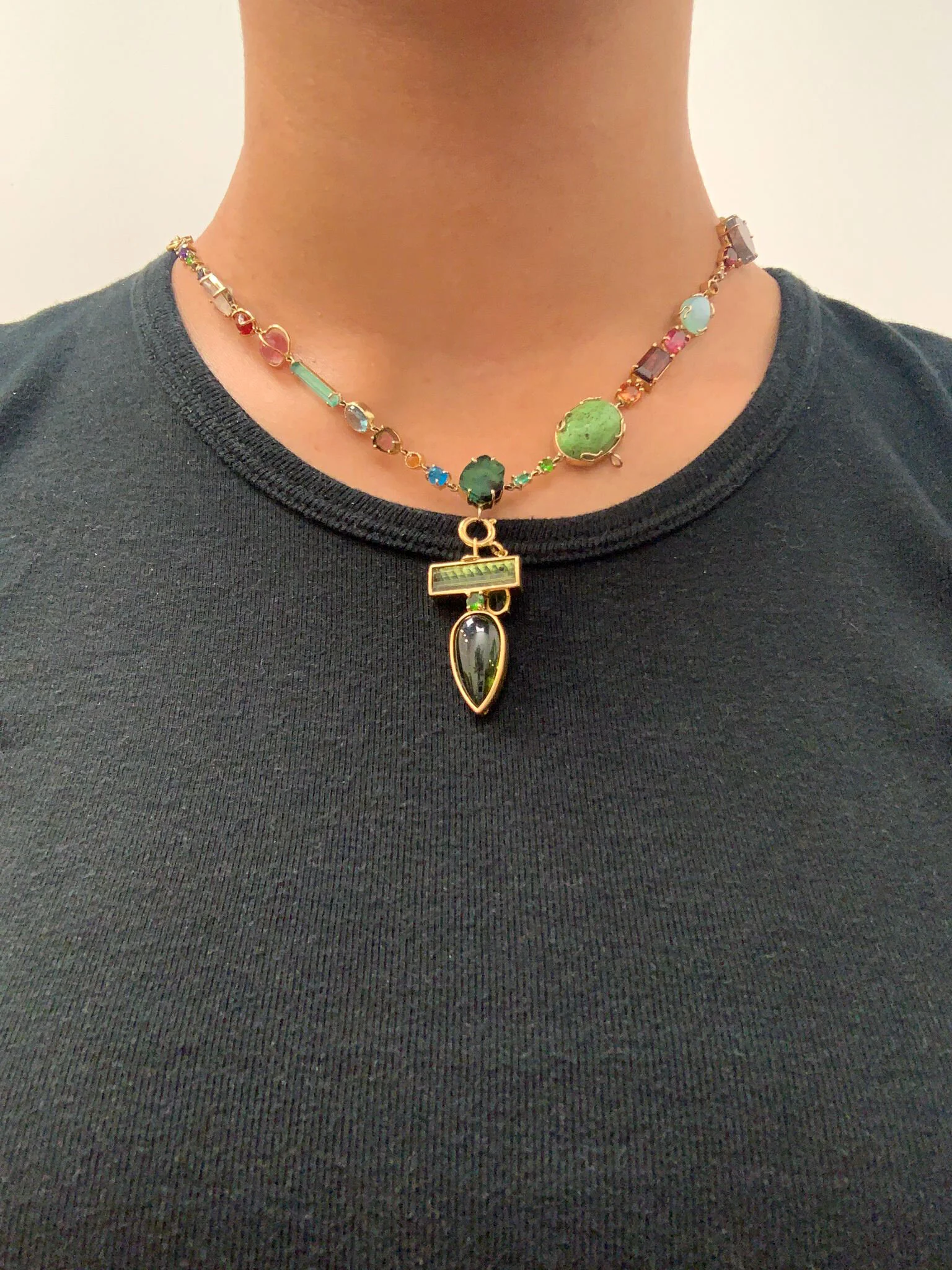  A length of jewels running along a classic scoop neck lends for a fresh take on a traditional silhouette. Adding a bold drop transforms the look from dainty to daring. 