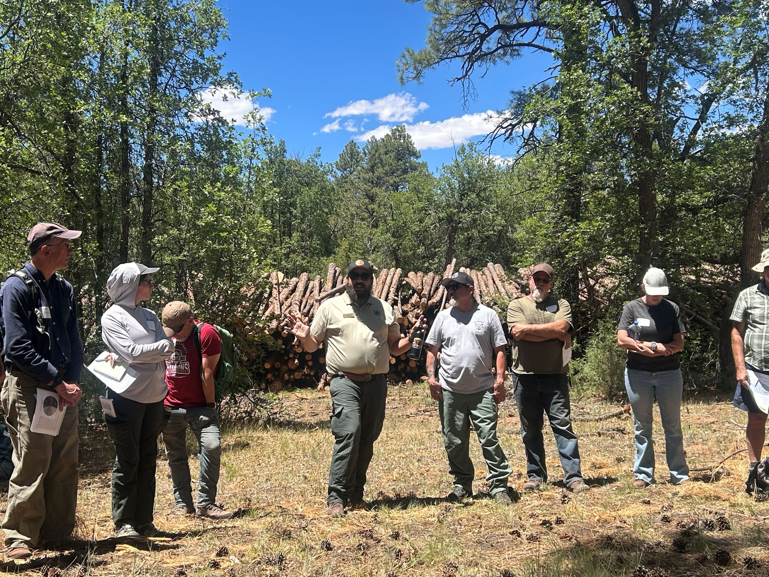  District Ranger Ryan Washam (center) spoke throughout the day about the importance of meaningful collaboration, the challenges of forest thinning and moving forest products (i.e. logs) off the landscape in rural areas, and what comes next for the Zu
