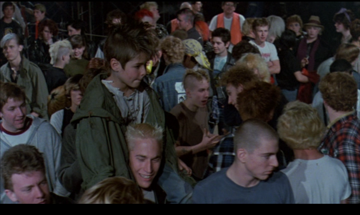 Ethan, now donning a mohawk, at a TSOL gig with his new family in Suburbia (Penelope Spheeris, New World Pictures, 1983)