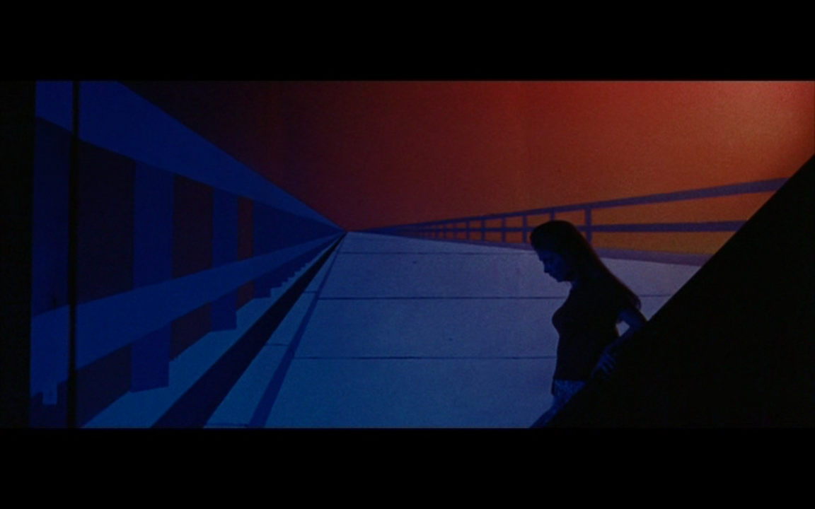 Arletty (Marianna Hill) descends down a long staircase into her father’s art studio in Messiah of Evil (Huyck and Katz, Bedford Entertainment, 1973).