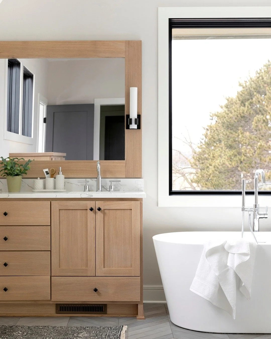 White oak cabinets are absolutely beautiful and something we love to use in our homes! This bathroom vanity and matching custom mirror are some features of a beautiful and thoughtfully designed custom home.

#bathroom #bathroomdesign #vanity #customh