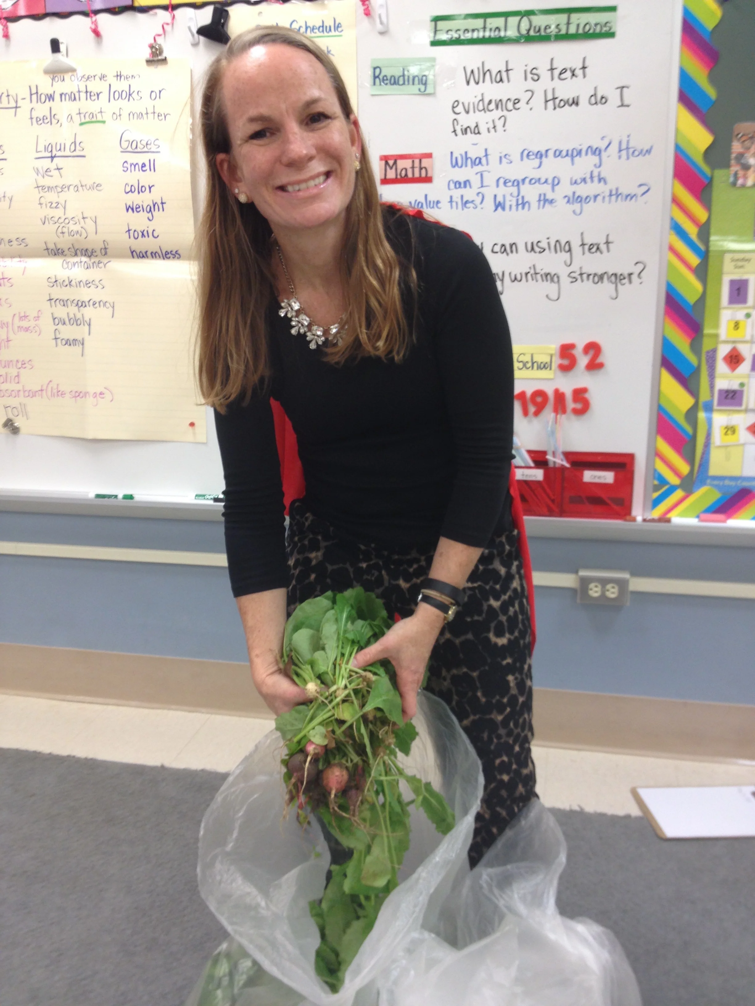 Wendy harvests radishes from school garden.