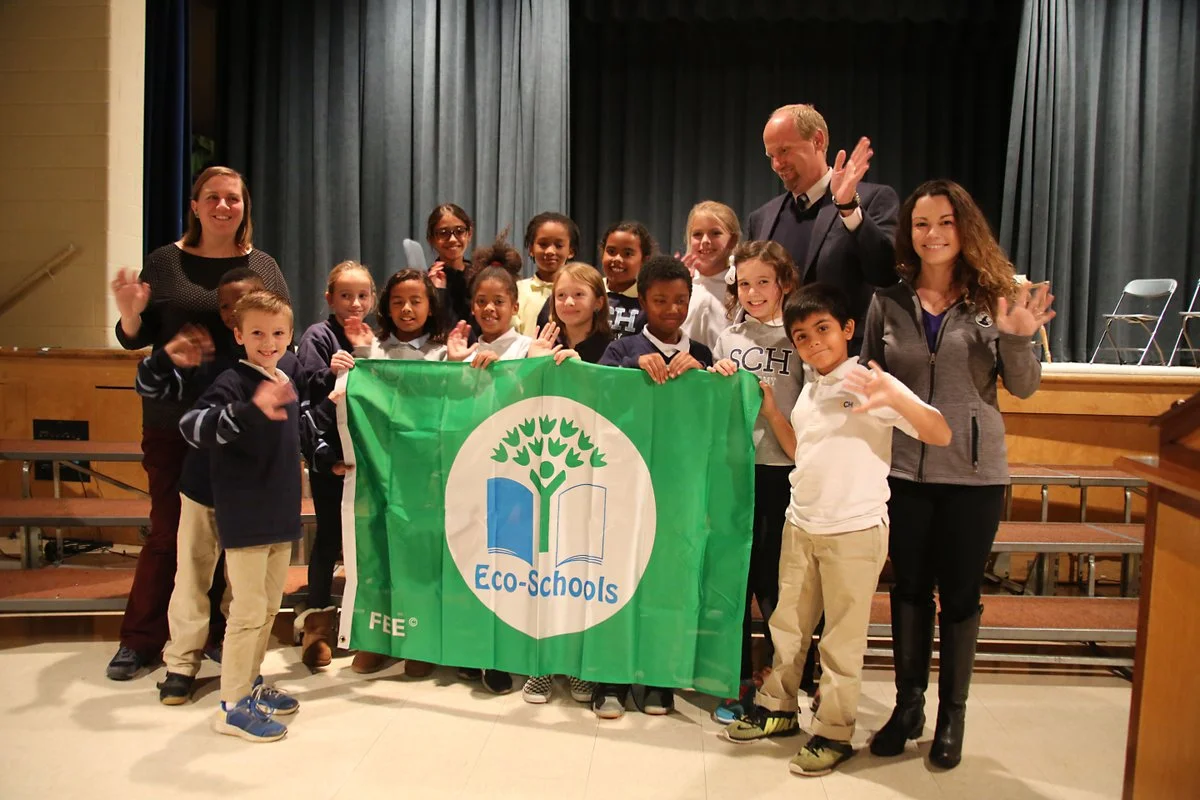 SCH Academy students celebrate the Green Flag award with Steve Druggan, Head of School, Ellen Kruger, Chair of the Green Task Force and Holly Shields of National Wildlife Federation.