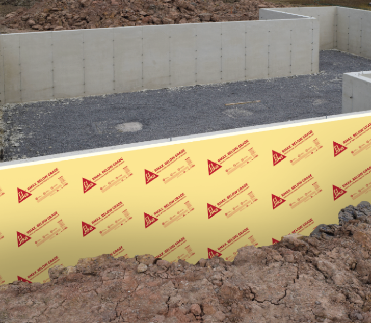 Concrete foundation wall with exterior insulation panels installed below grade.