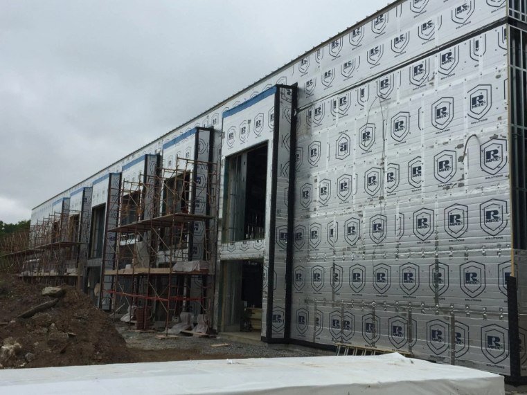 Commercial building with continuous exterior insulation installed during construction.