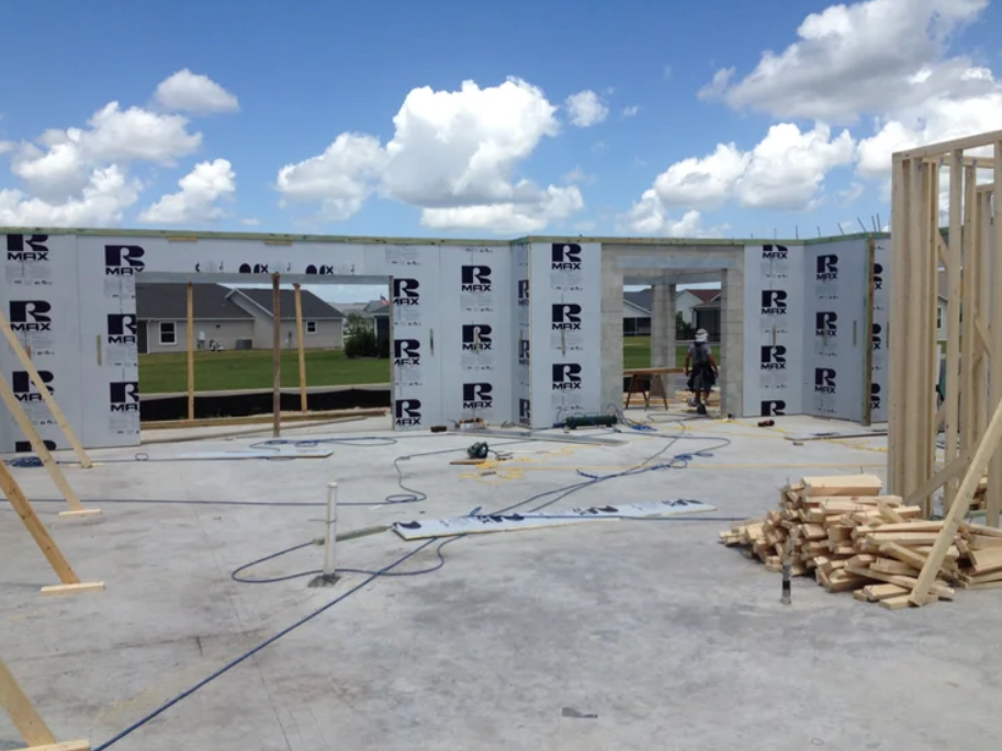 Residential home under construction, comparing polyiso insulation vs XPS for exterior wall insulation.