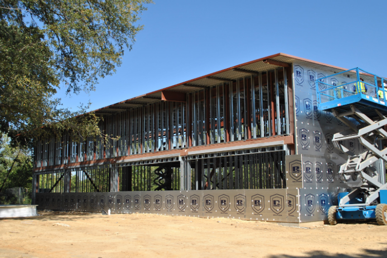 Polyiso continuous insulation applied to exterior wall system on multi story commercial building.