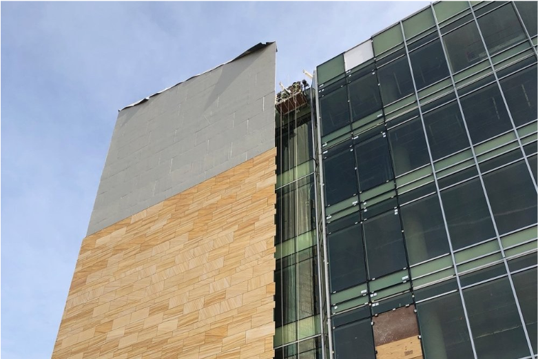 Exterior wall showing polyiso continuous insulation with cladding attachment in progress