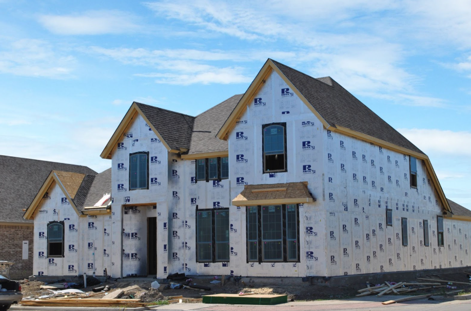 Interior framing stage highlighting polyiso insulation vs XPS applied to concrete slab foundation walls.