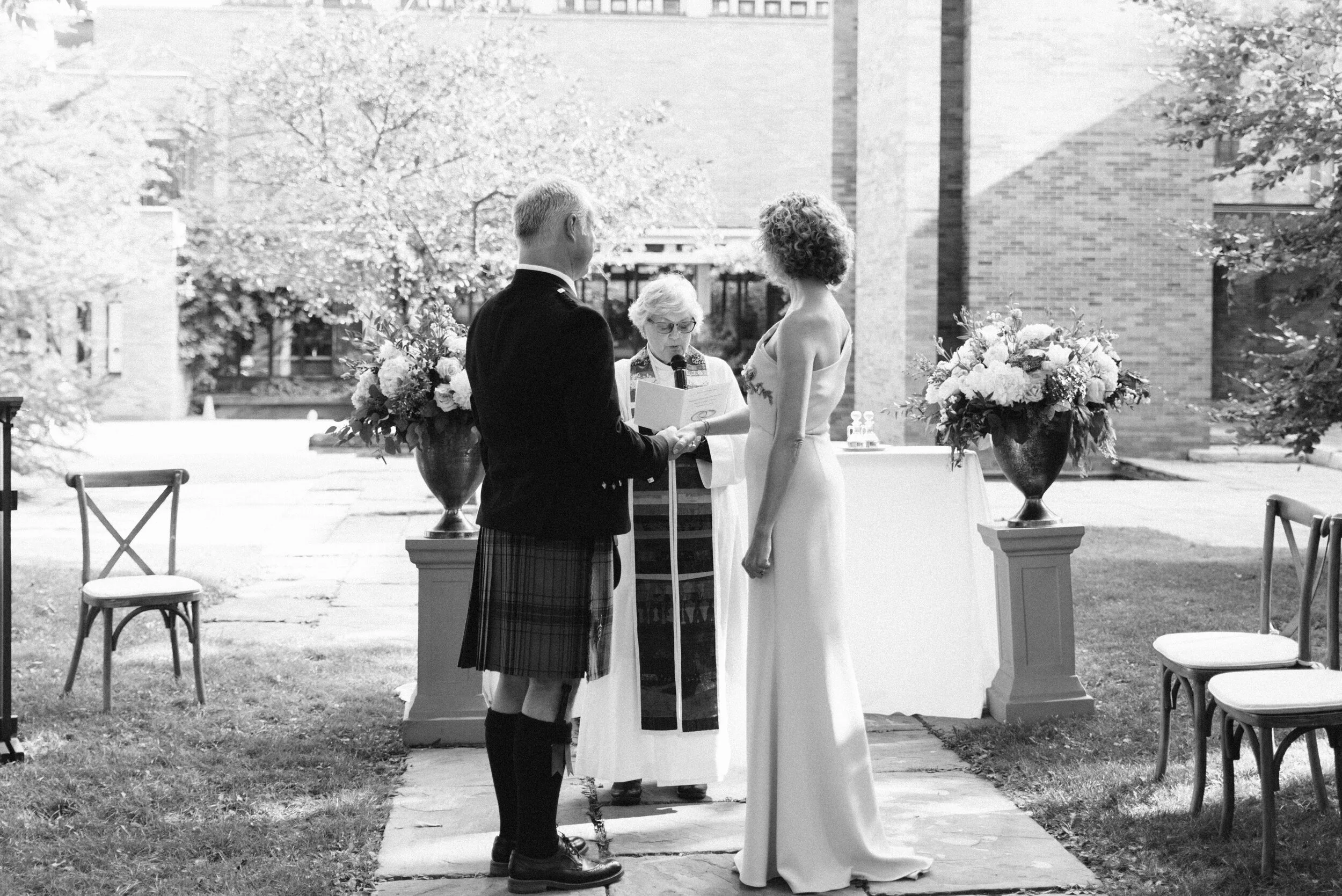 Black and white photo of bride and groom at the altar Massey College wedding