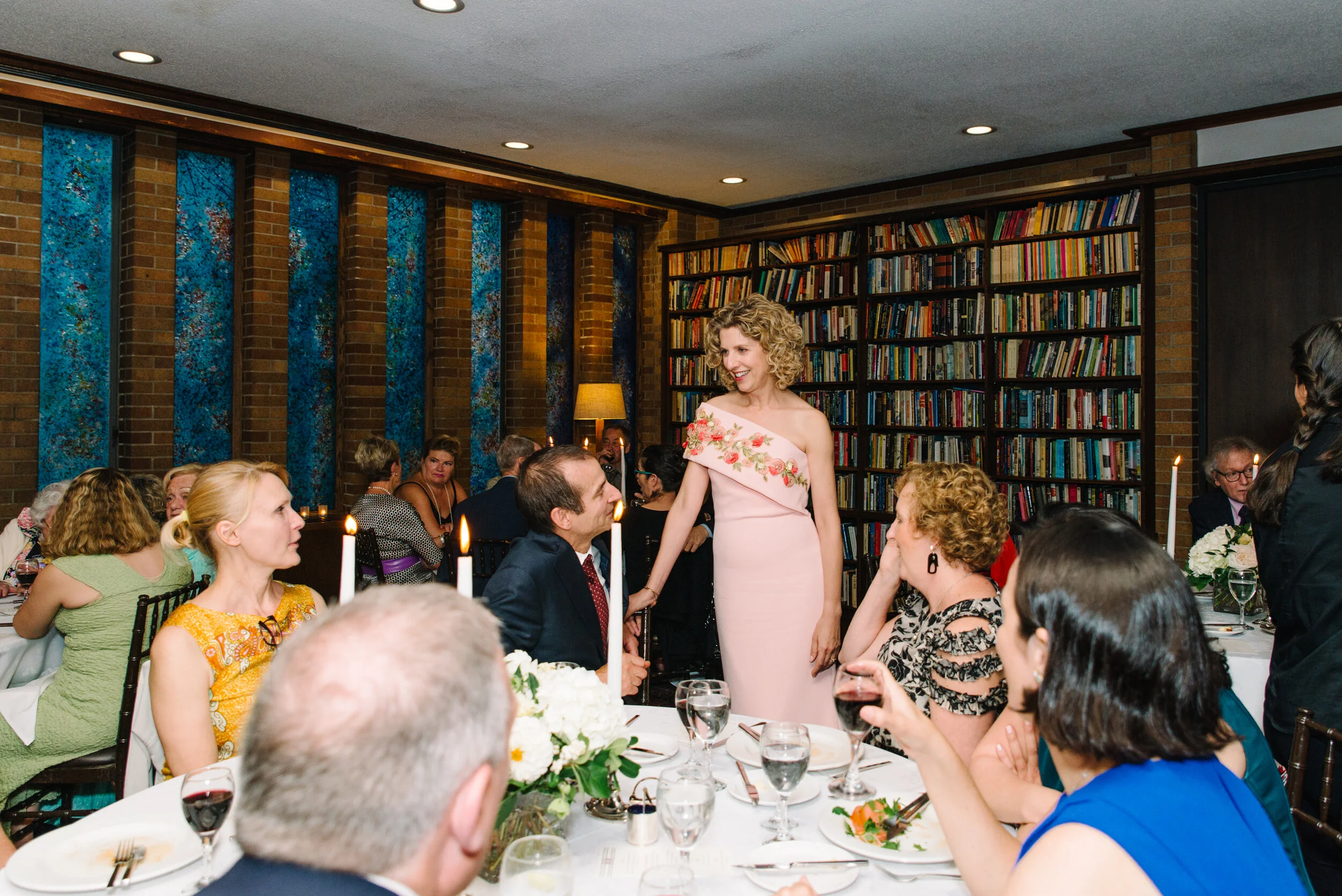 Bride mingling with guests during wedding dinner at Massey College Toronto