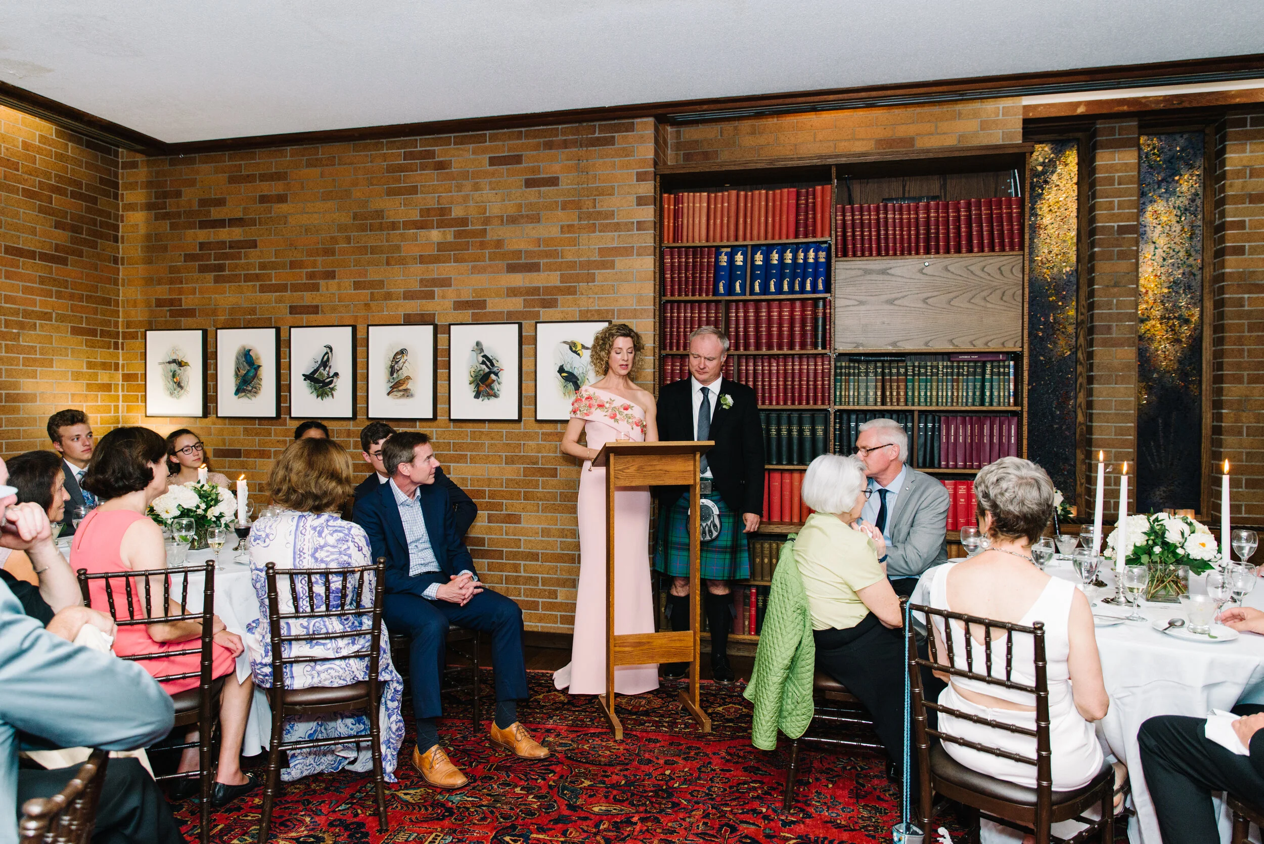 Bride and groom giving speech during wedding dinner at Massey College Toronto