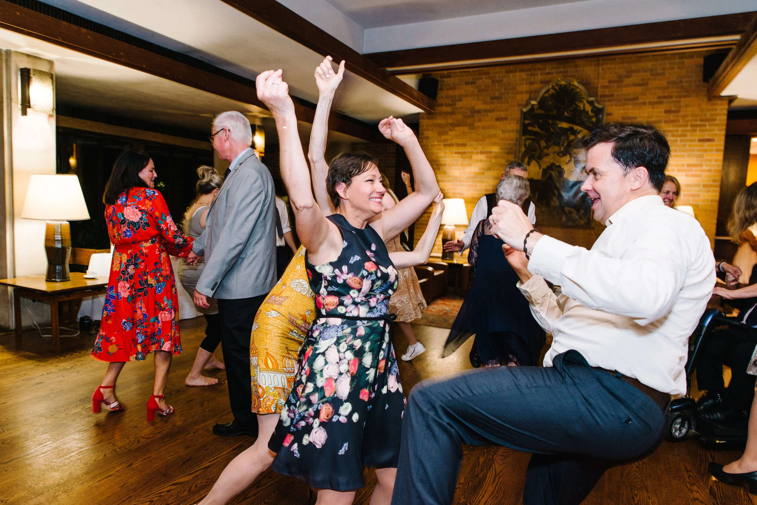 Candid photo of guests dancing at Massey College wedding reception Toronto