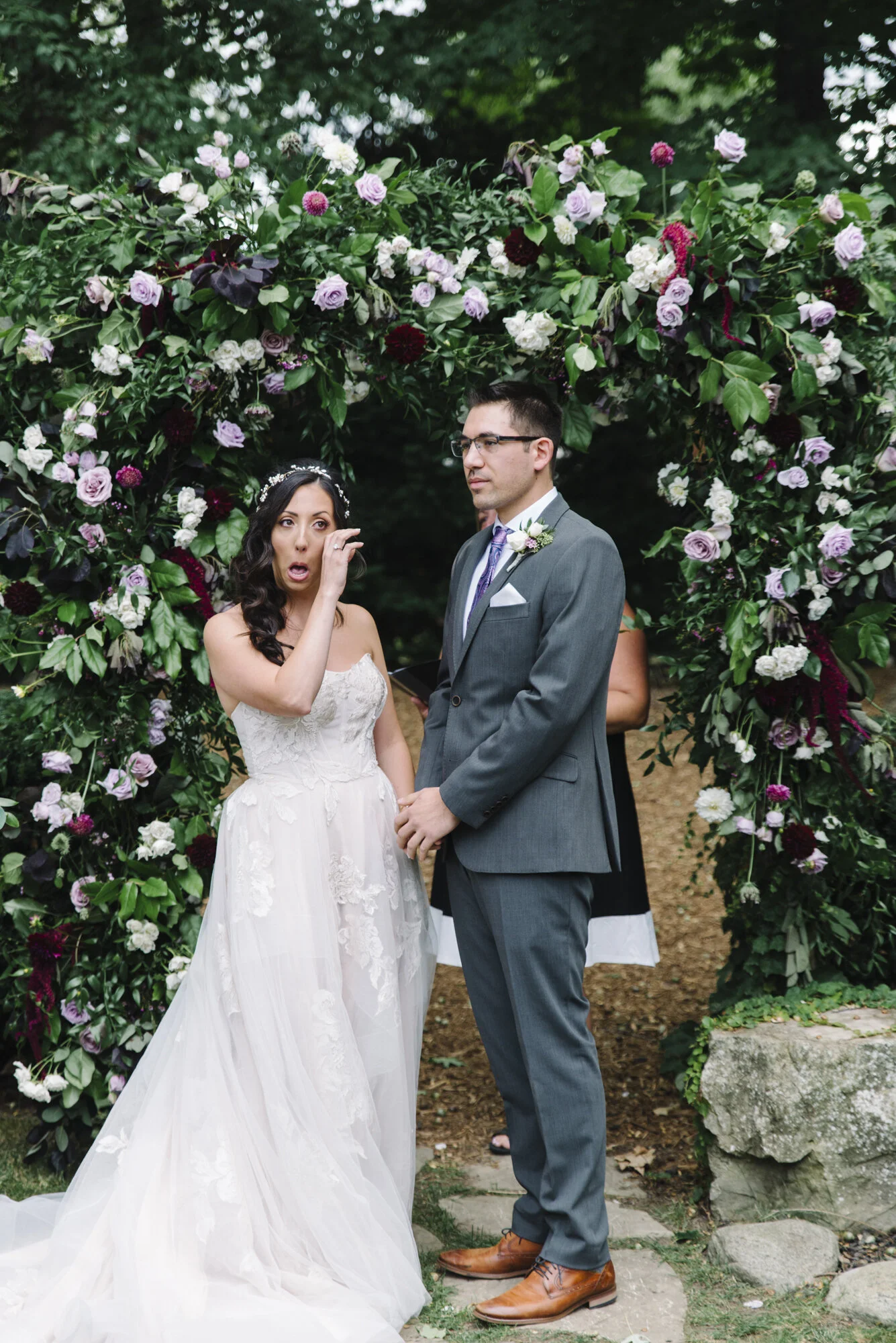 Candid photo of a bride feeling emotional during her intimate backyard micro-wedding ceremony in Mississauga