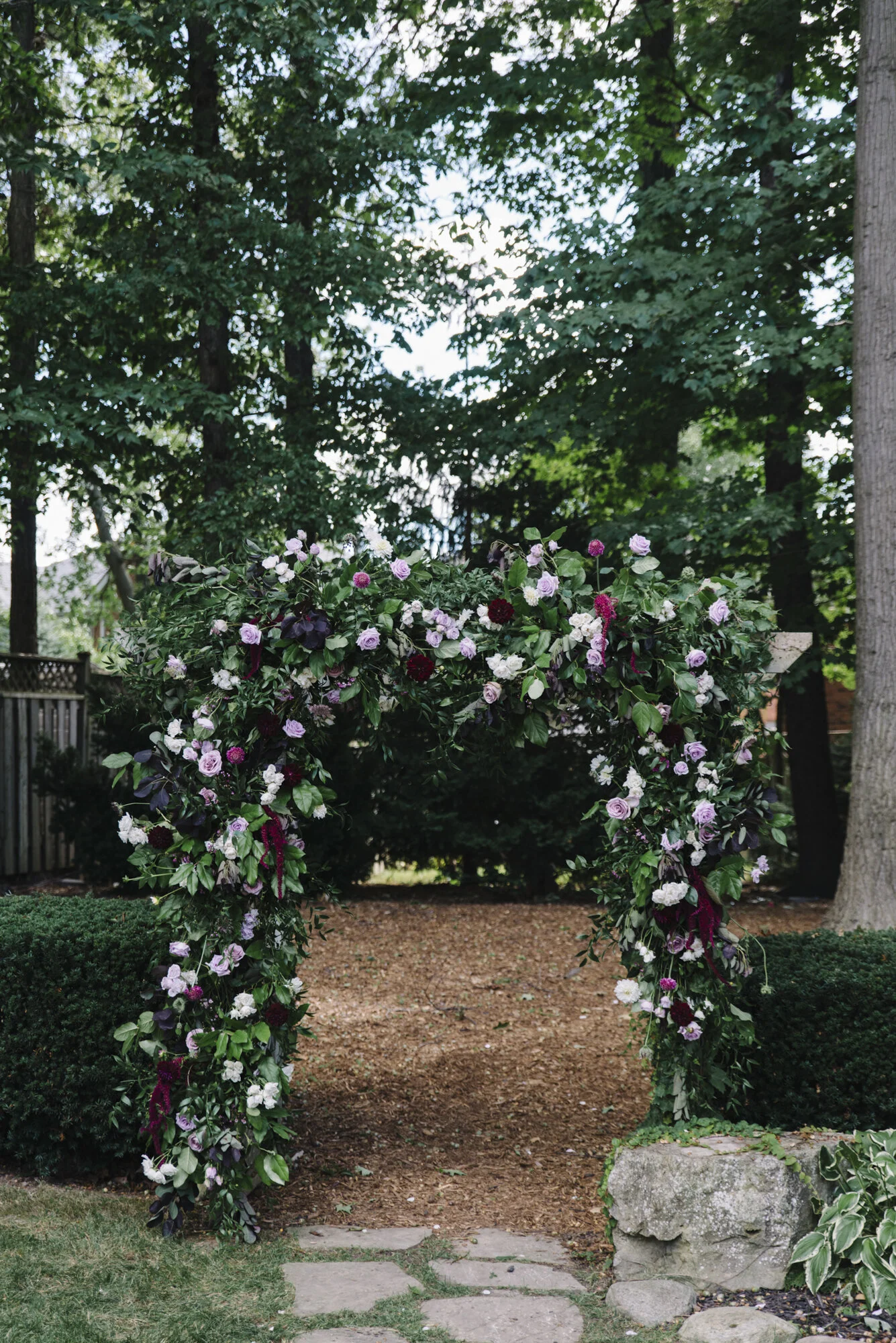 Detail photo of a stunning wedding ceremony floral arch by The Paisley Rose at a backyard micro-wedding in Mississauga