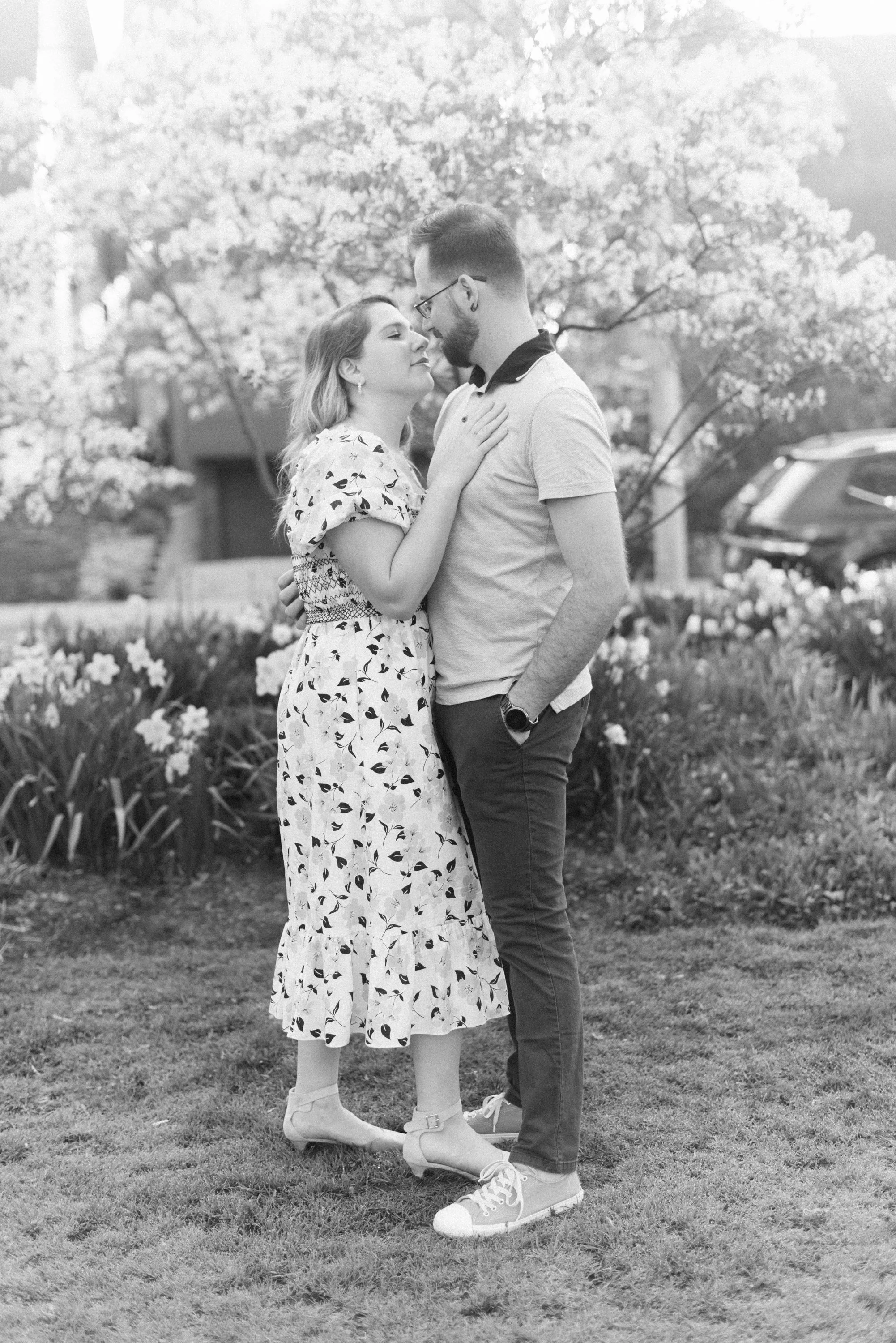 Black and white romantic portrait of a couple during their sunrise engagement session at Woodbine Beach, Toronto