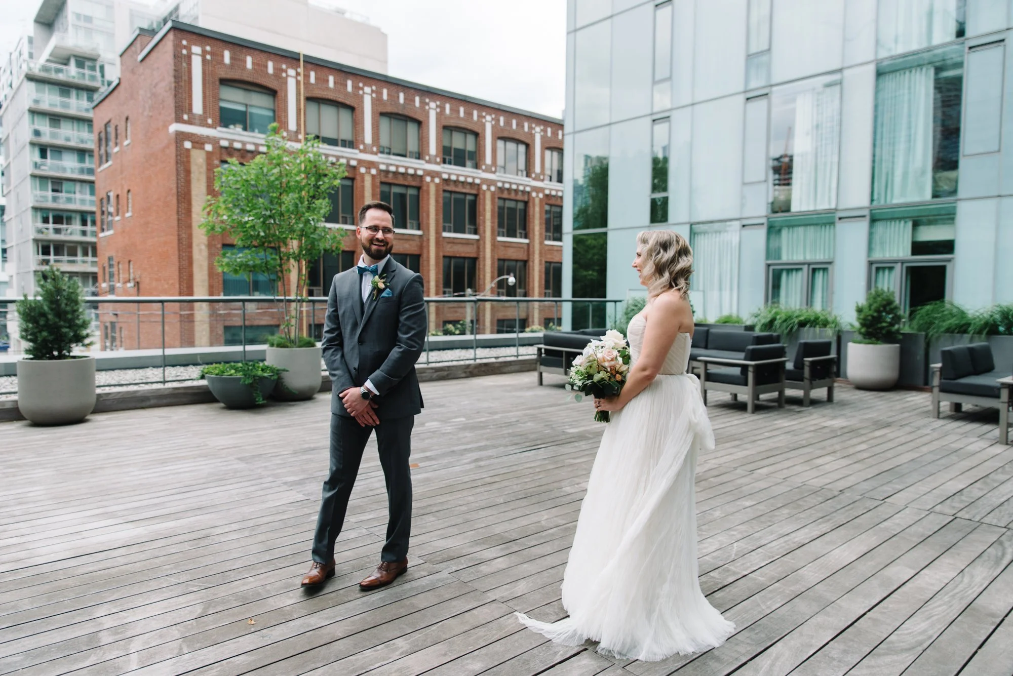 Bride and groom sharing a touching first look on the rooftop at 1 Hotel Toronto