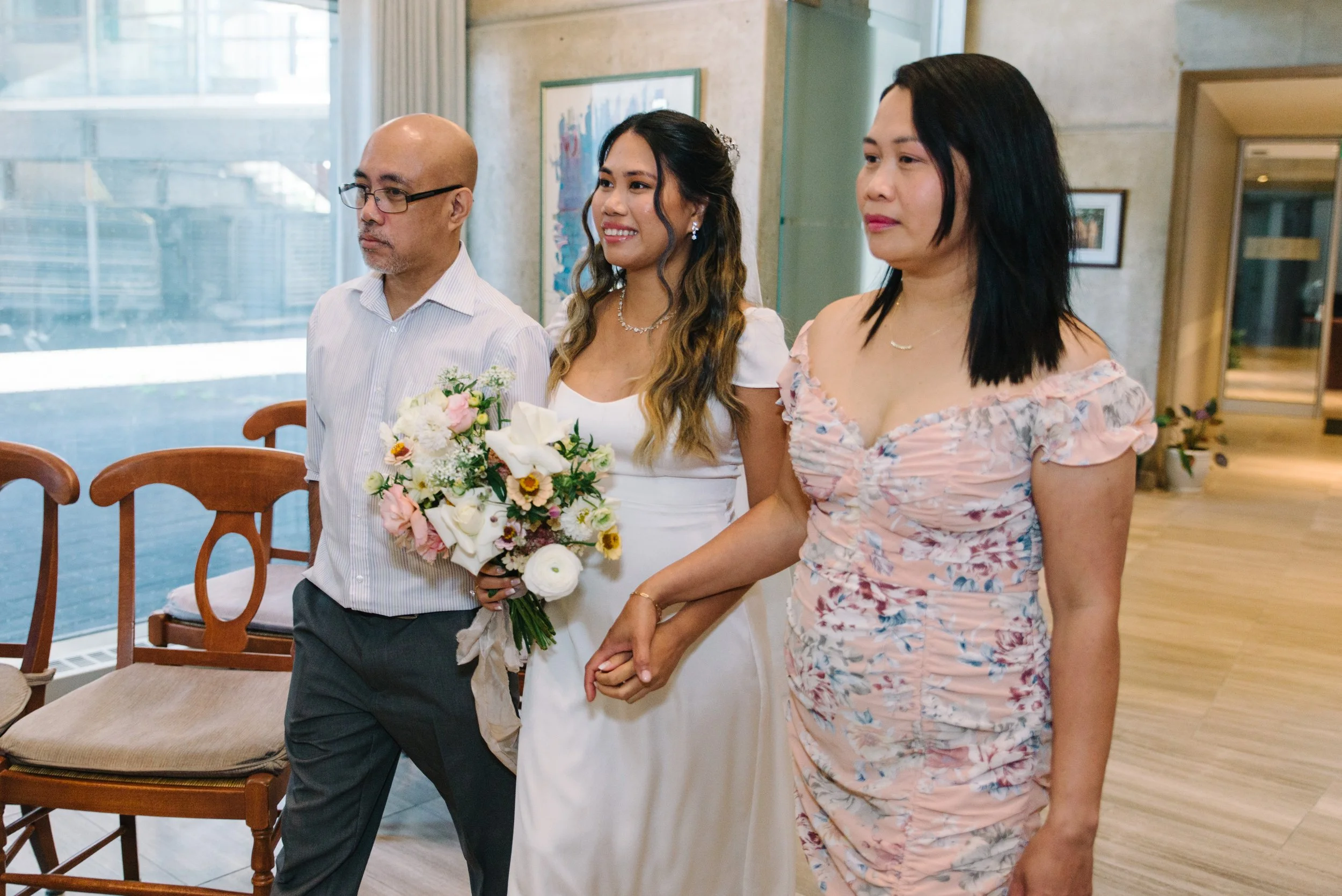 Candid photo of a bride walking into her elopement ceremony at Toronto City Hall