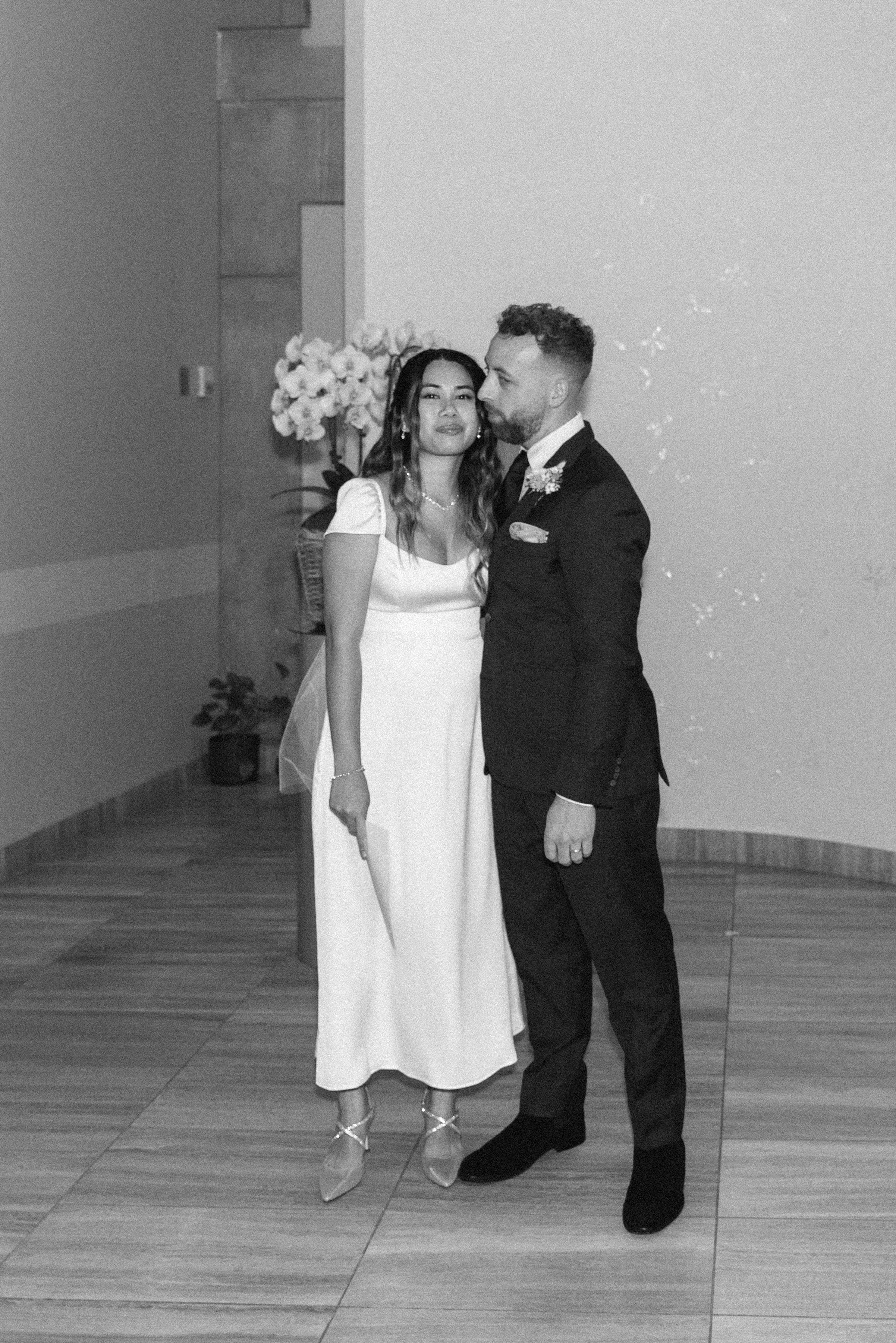 Black and white film candid of a bride and groom during their elopement ceremony at Toronto City Hall